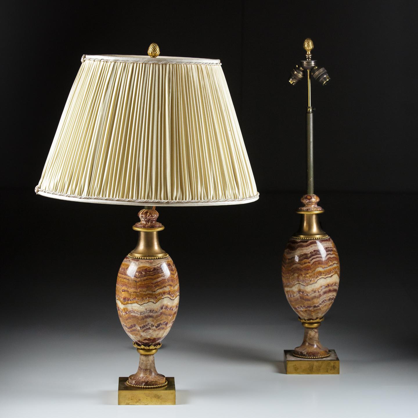 Pair of large Maison Charles Style Onyx table lamps.

Impressive scale onxy and brass table lamps, rise and fall mechanism with  double lamp holder. Switched antique cord, rewired and PAT tested to UK standard. USA wiring possible.
Excellent