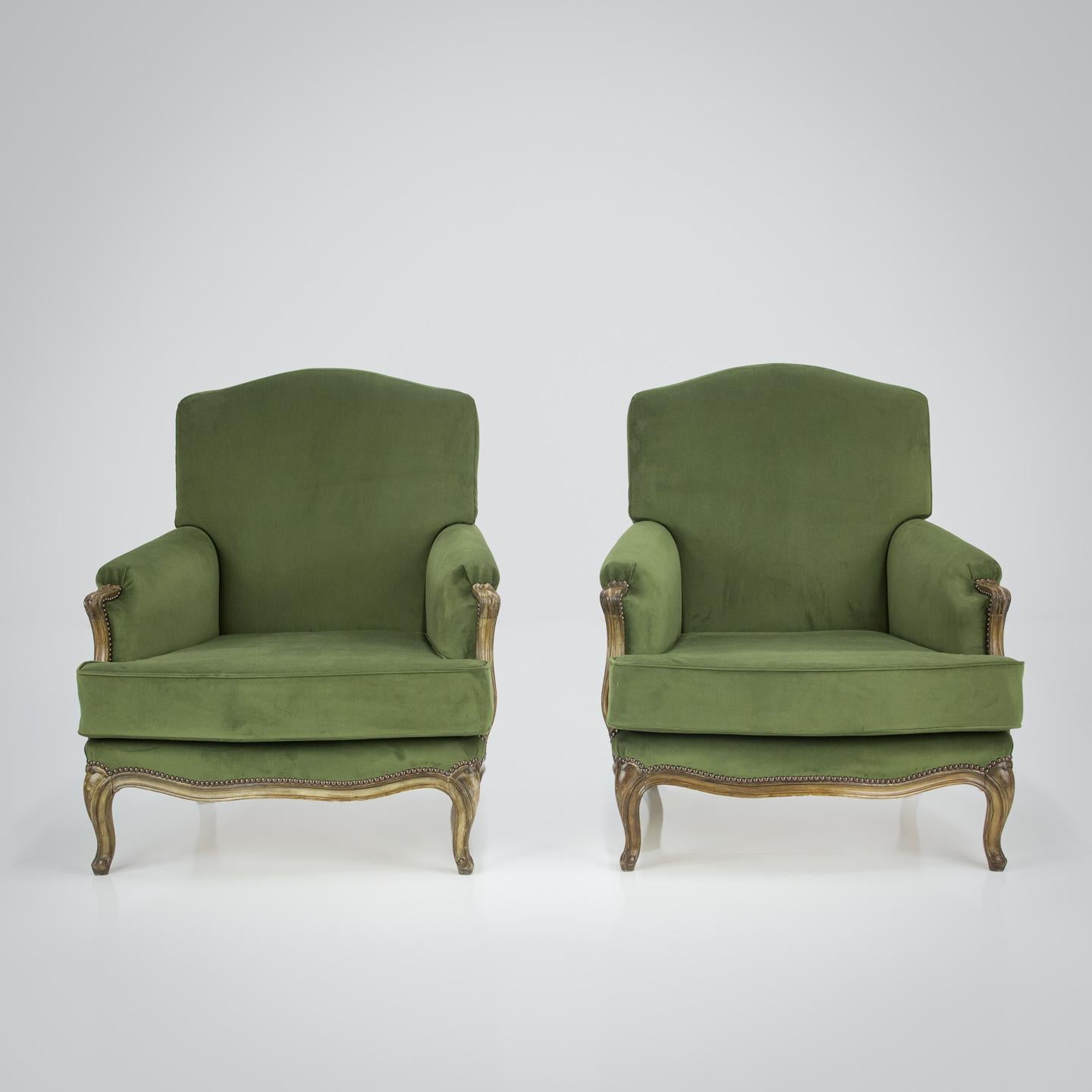 Pair of Louis XV Style Armchairs, once painted, faded frames, smart cabriole legs and shapely lower rail. Upholstered using a traditional French nailed finish in Dark Green Velvet.  Very Much in the Maison Jansen Style.

France Circa 1950.