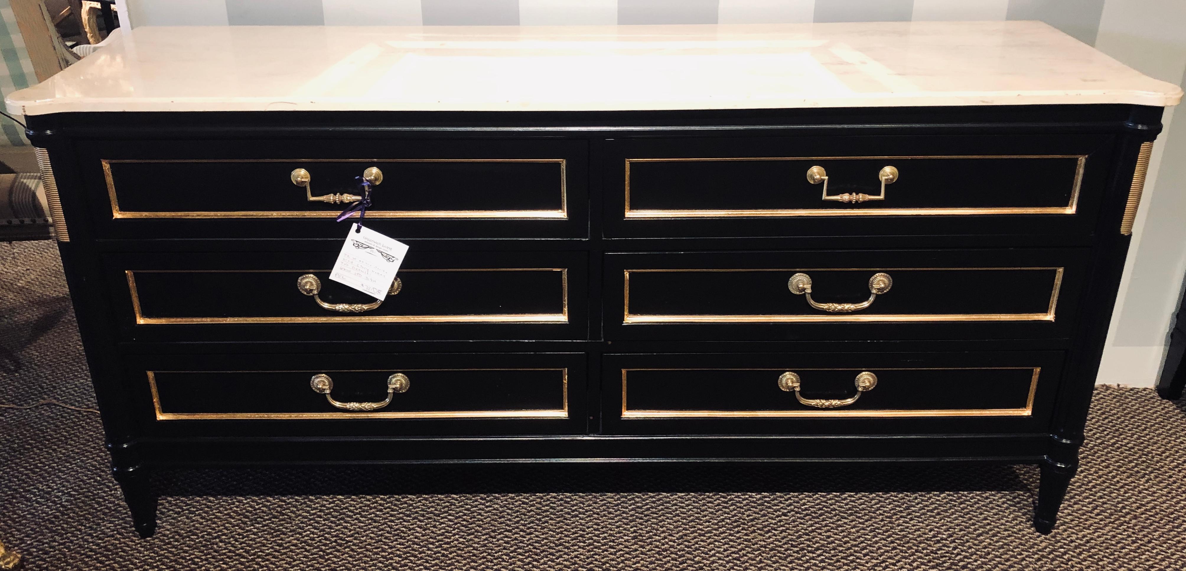 Pair of Maison Jansen style ebony marble-top dressers commodes chest of drawers. Each in the Louis XVI style with ebony and bronze adorned decoration this stunning pair of palatial servers or dresser are multi functional and can be used in many