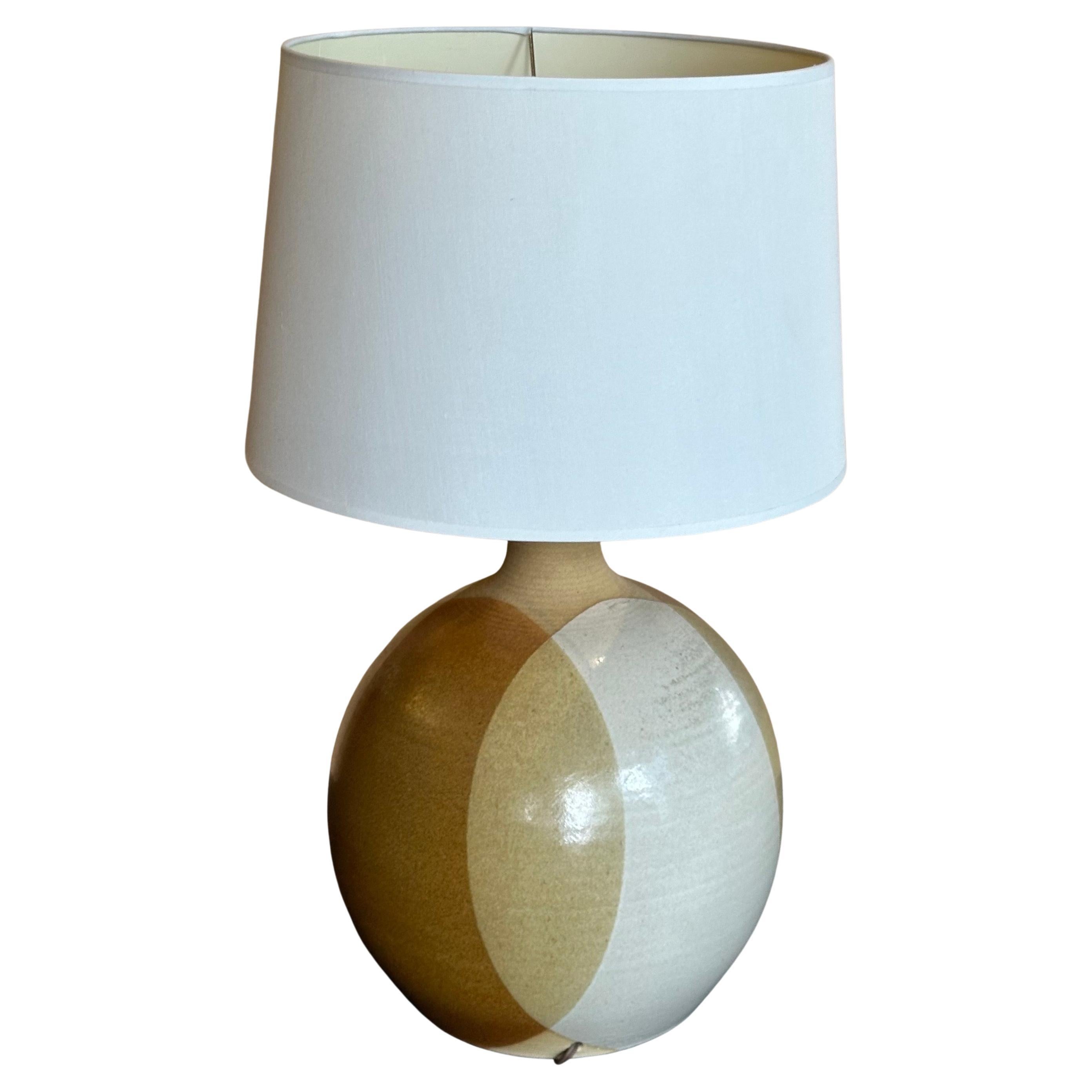 Pair of large MCM studio pottery stoneware table lamps by Larry & Terry Brown, circa 1970s.  The lamp is in very good working condition and measures 12