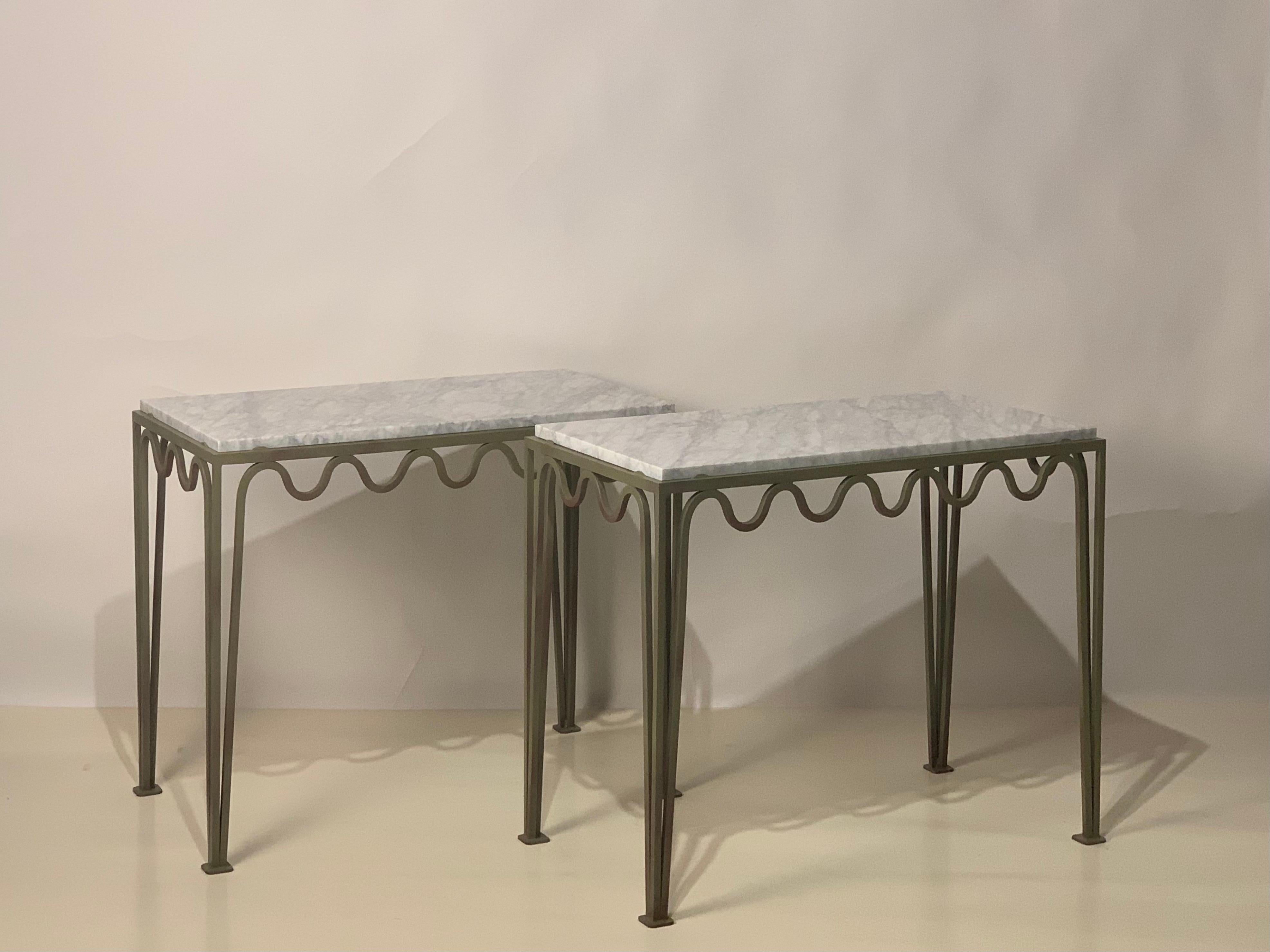 Gorgeous veined white marble tops fitted over meandering verdigris steel frames. Beautifully simple, understated design.

These consoles from our exclusive Design Frères line are handmade in our Los Angeles atelier by our skilled artisans. These