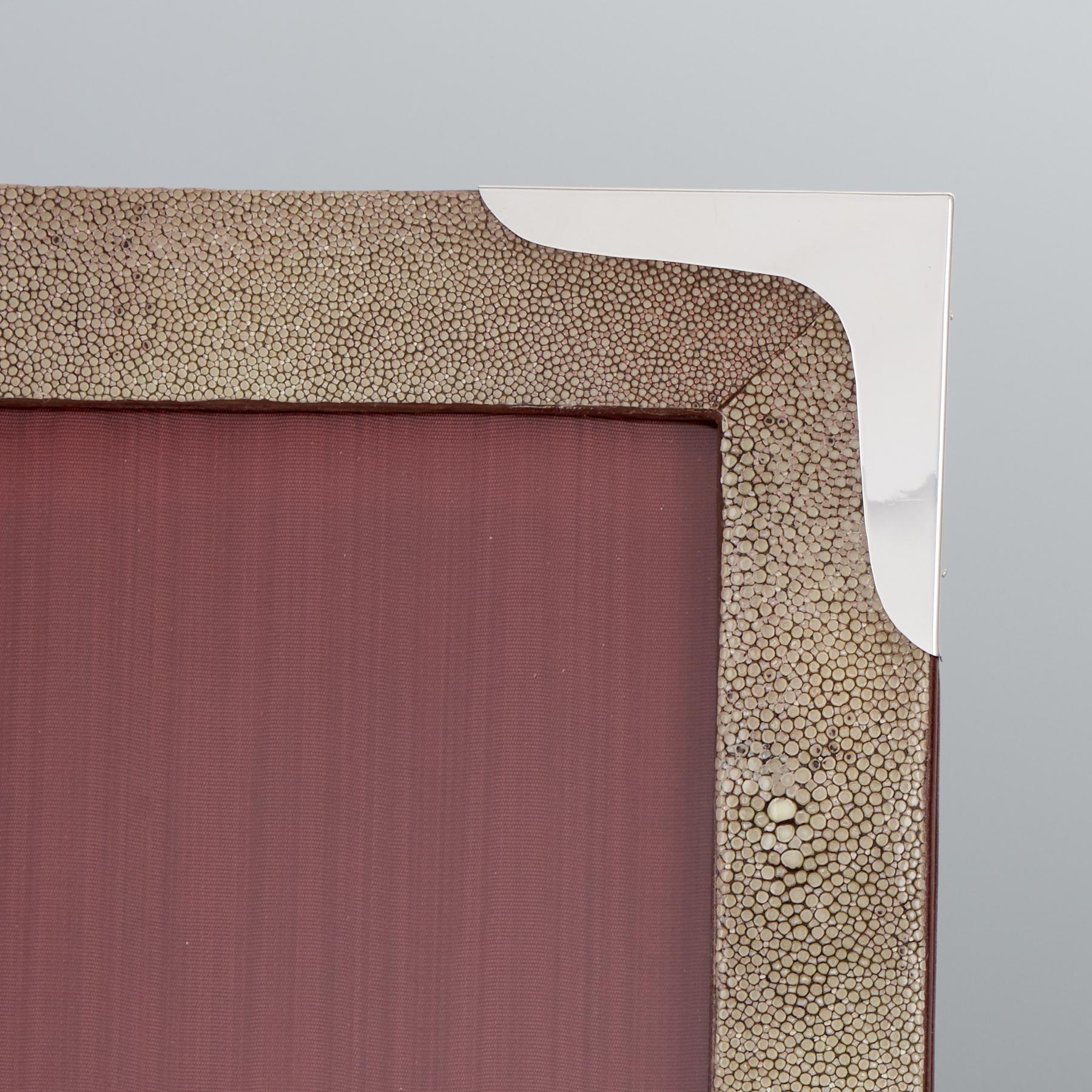 A pair of large mid-20th century shagreen photo frames with silver corners circa 1960.
This great pair of shagreen frames in a beautiful muted taupe color the silver corners are unmarked.
The backs and easel supports are in morocco leather origin