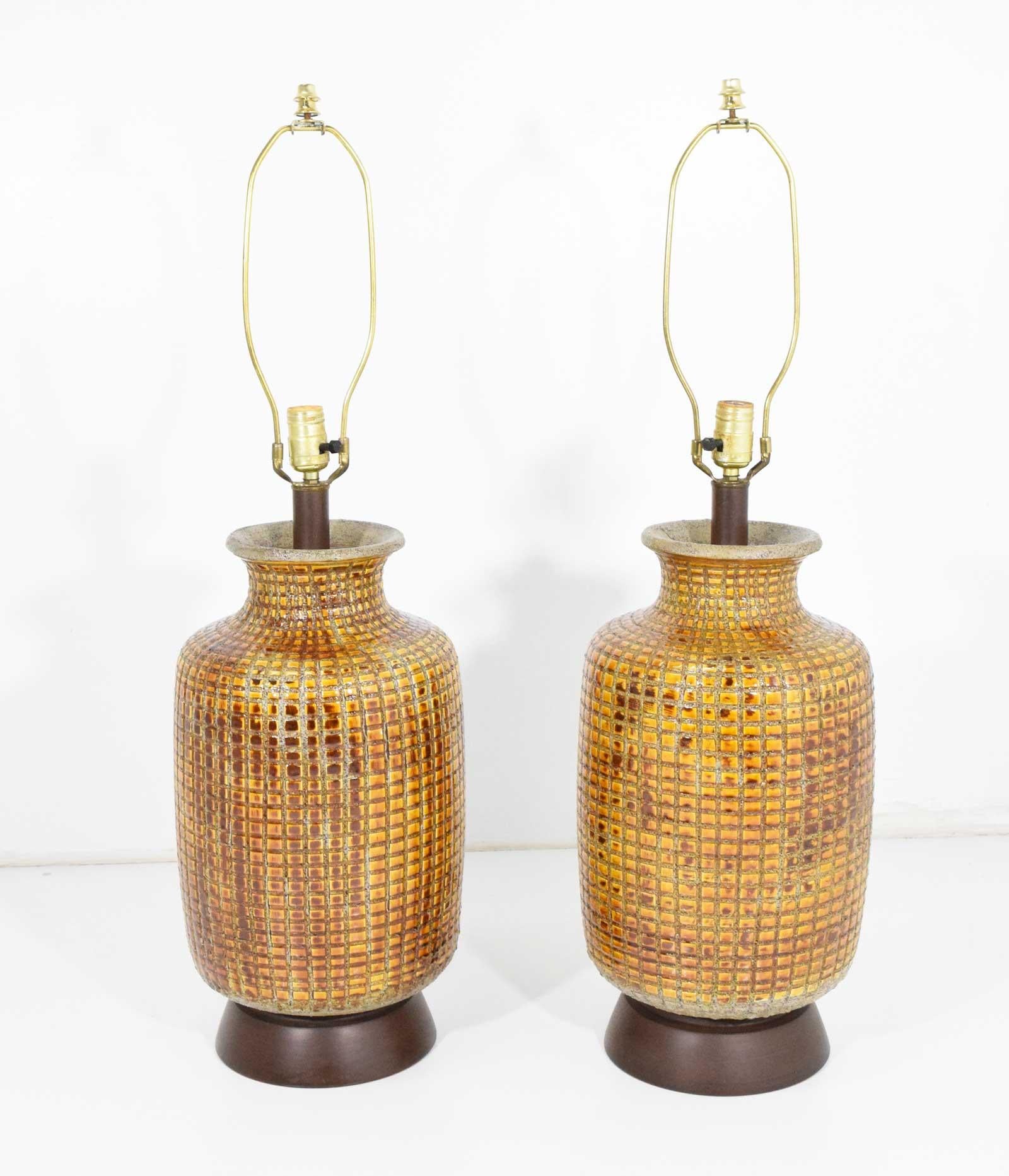 Beautiful pair of large midcentury table lamps. Ceramic is deeply incised and handcut tile is inlaid to create pattern. Shades not included. Measurement is to socket.