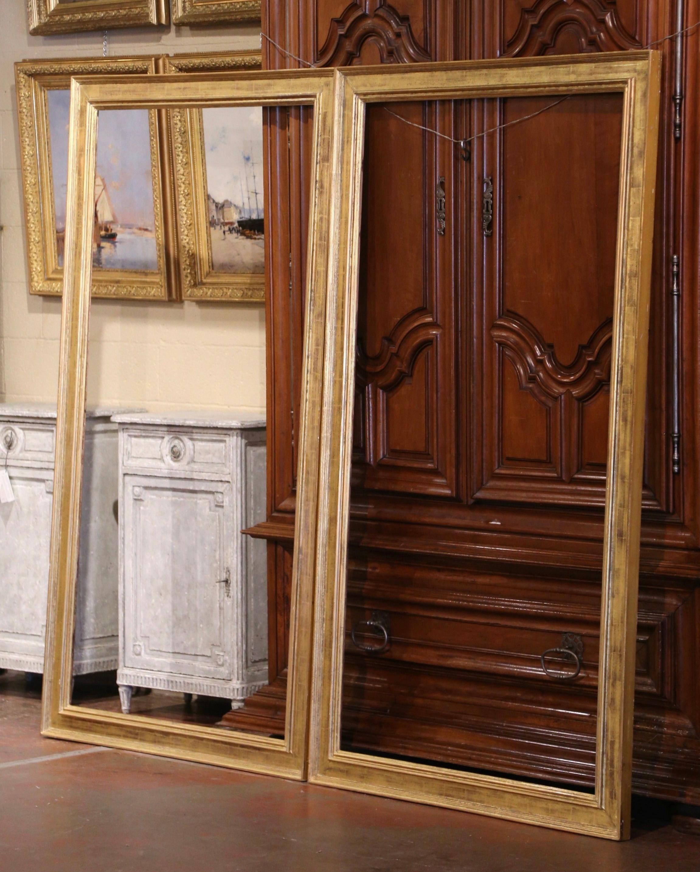 These monumental matching gilt wood frames were created in France circa 1950. Almost 7 feet tall, each frame could be used to host any large artwork, or be fitted with mirrored glass and used as floor or full length mirrors in a master bathroom,