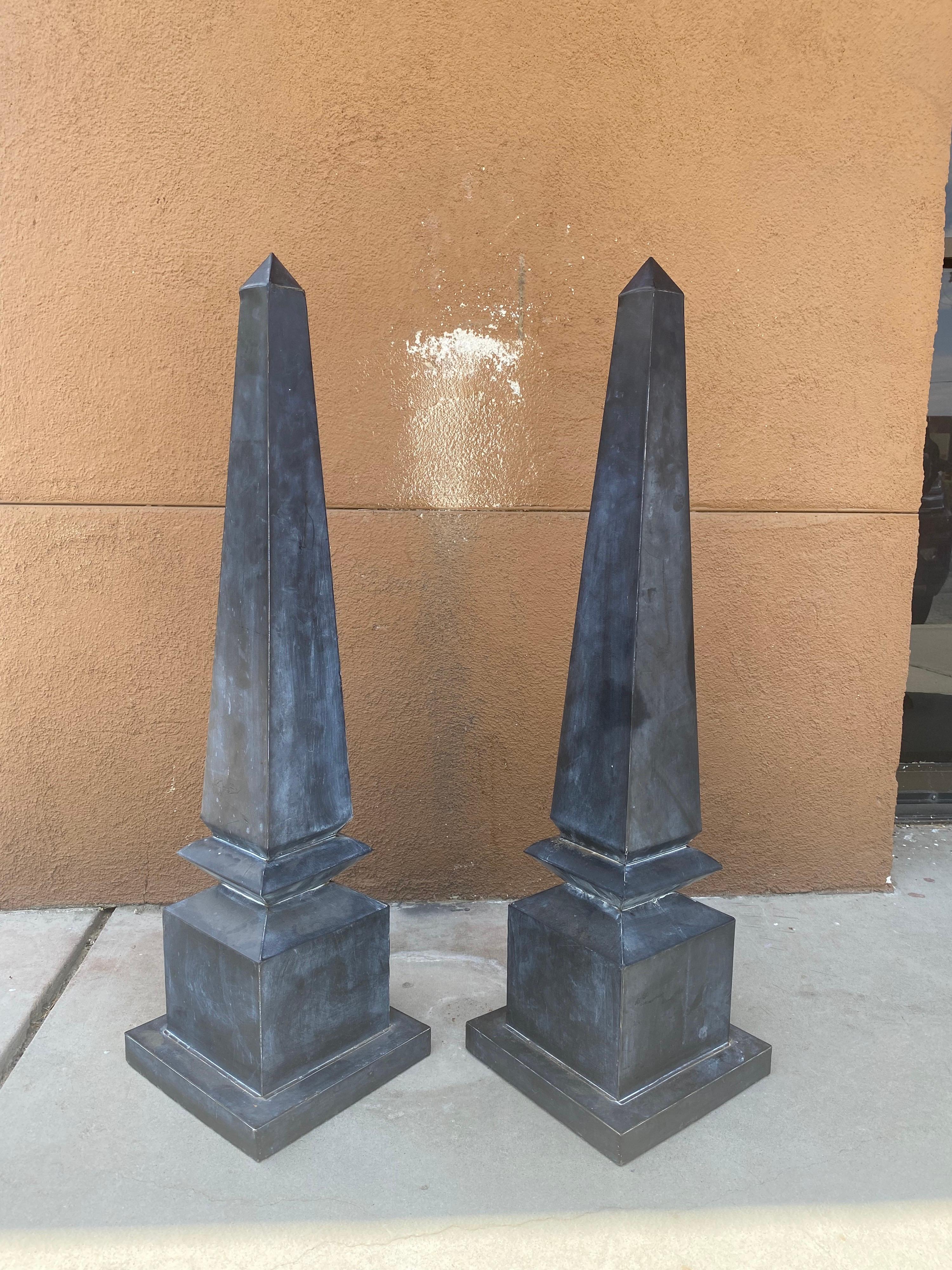 We found these beautiful large obelisks in a landscape design of a MAJOR regency style Beverly Hills home.. (think movie mogul John Elgin Woolf estate and you got the look!) I believe them to be custom-made. Dark gray or light black beautiful all