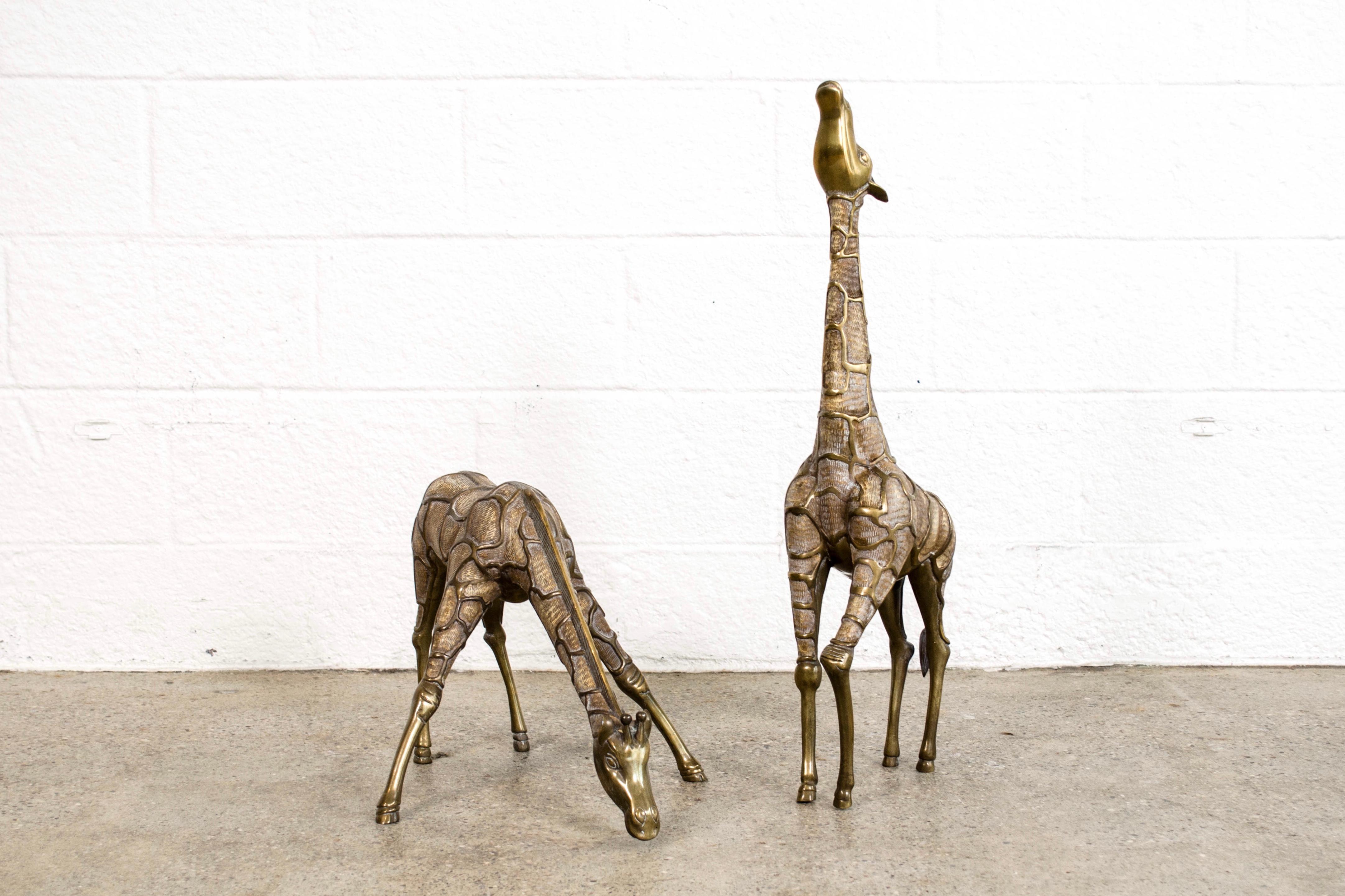 This pair of large vintage modernist solid brass floor statue giraffes are beautifully elegant. With gorgeous detailing they are uniquely posed with a grazing female and male with long, outstretched neck standing tall at 28 1/2”. A truly