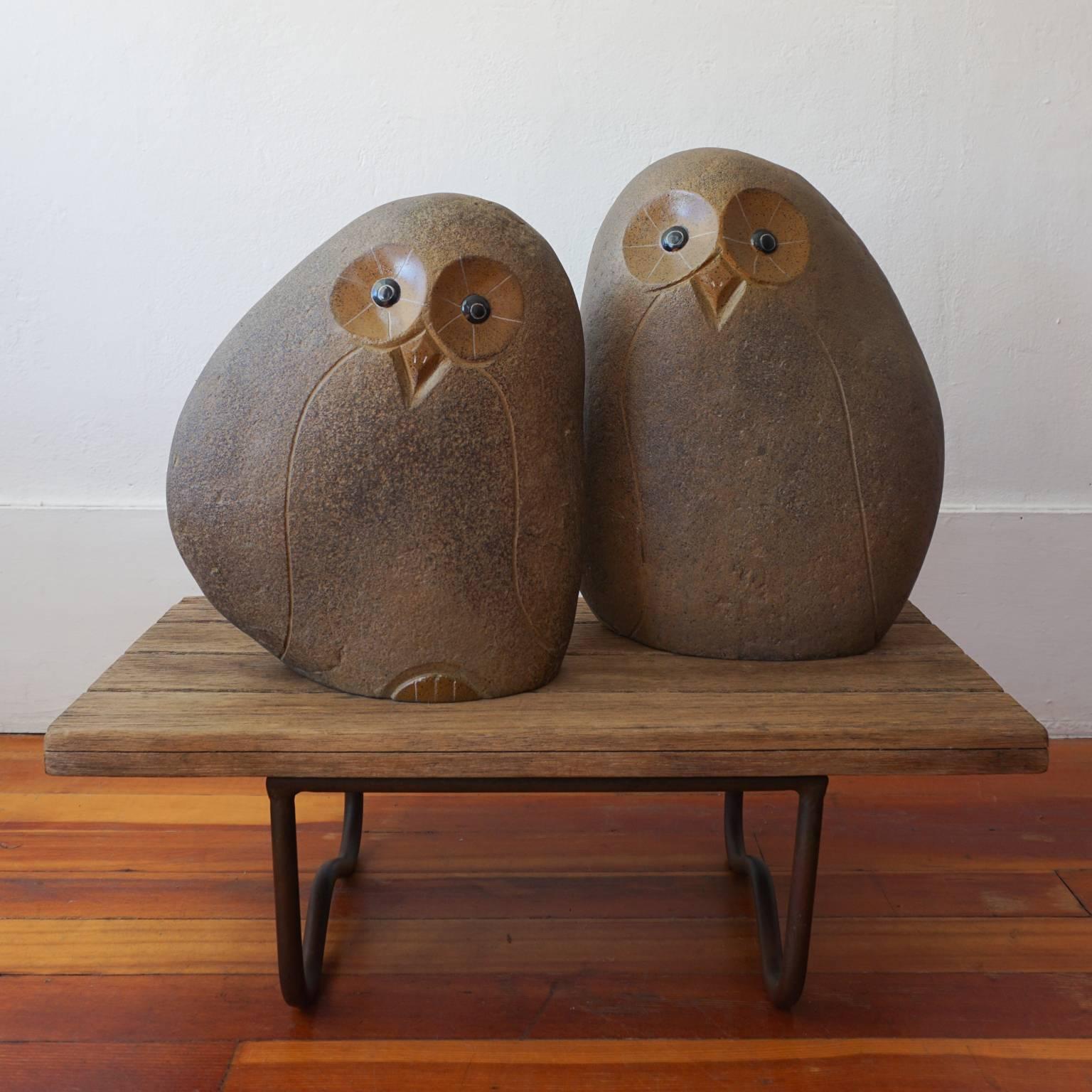 Two large-scale 1960s owl statues. Rock texture and hollow form. Made of a ceramic and fiberglass material. 

Measures: Large owl is 18.5