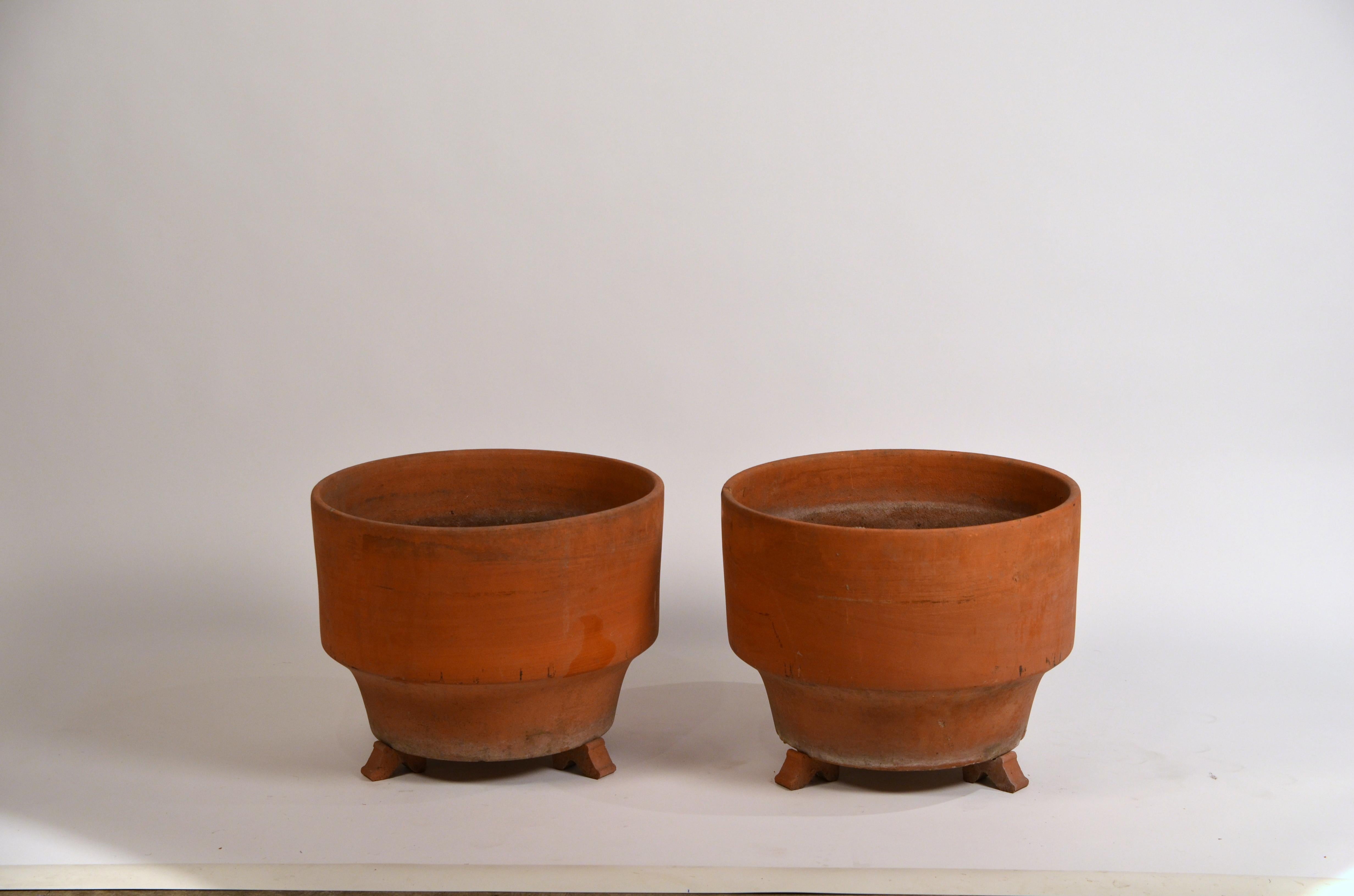 Pair of large midcentury unglazed terracotta planters on stands (optional).
