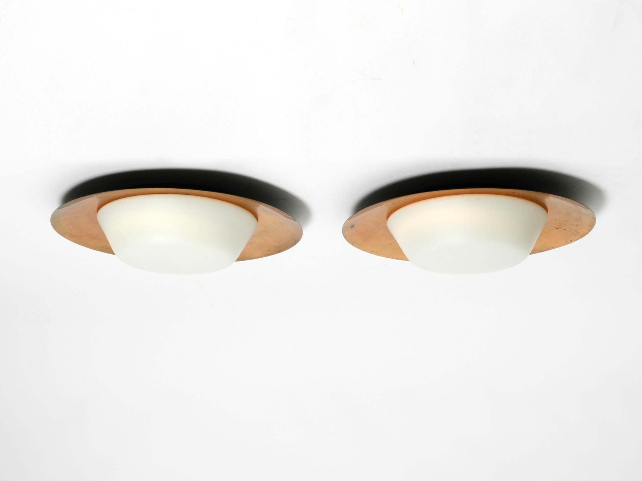 German Pair of large Mid Century wall or ceiling lamps made of glass with copper-plated For Sale