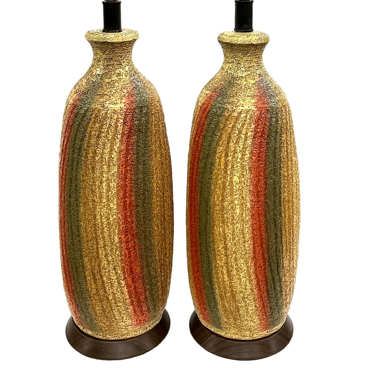 Pair of circa 1960's Italian striped lamps with yellows and oranges.

Measurements:
Height of body: 23