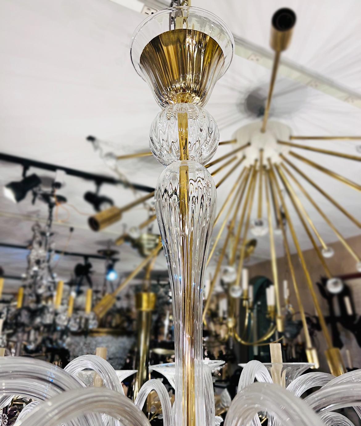 A Pair of circa 1960's Italian clear Murano glass chandeliers with 12 lights. Sold individually.

Measurements:
Diameter: 44