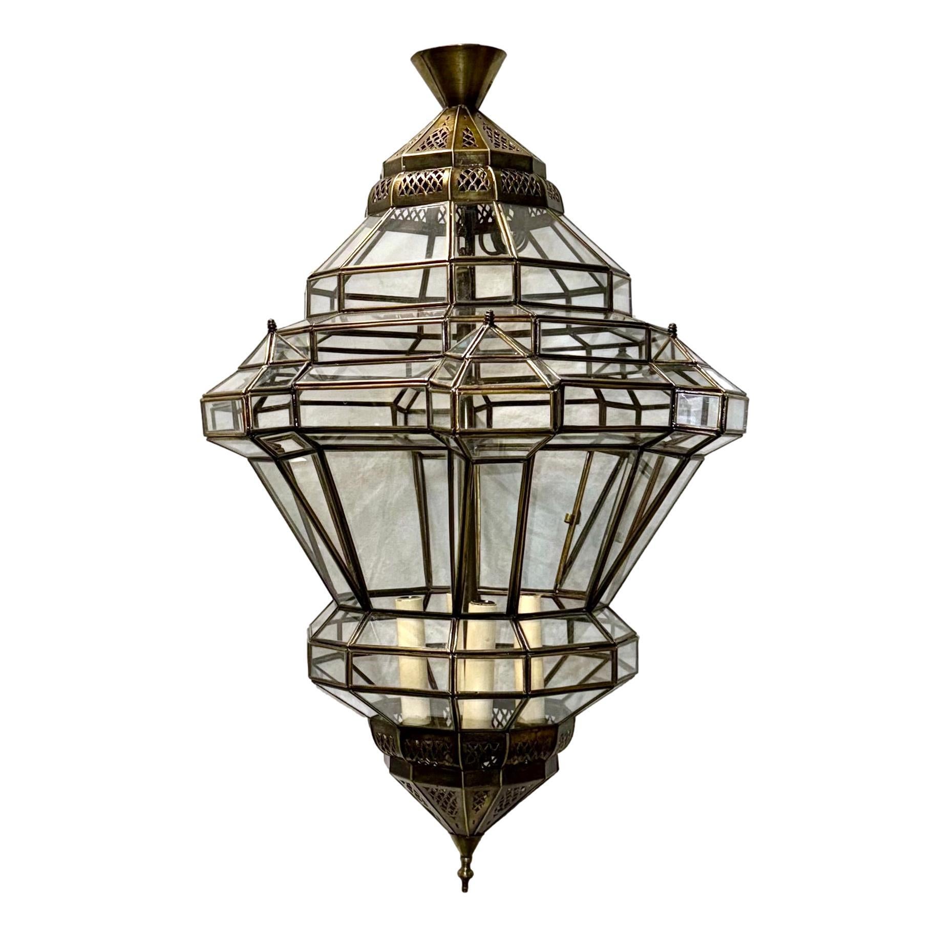 Pair of circa 1960's Moroccan metal lanterns with glass panels. Sold individually.

Measurements:
Drop: 34