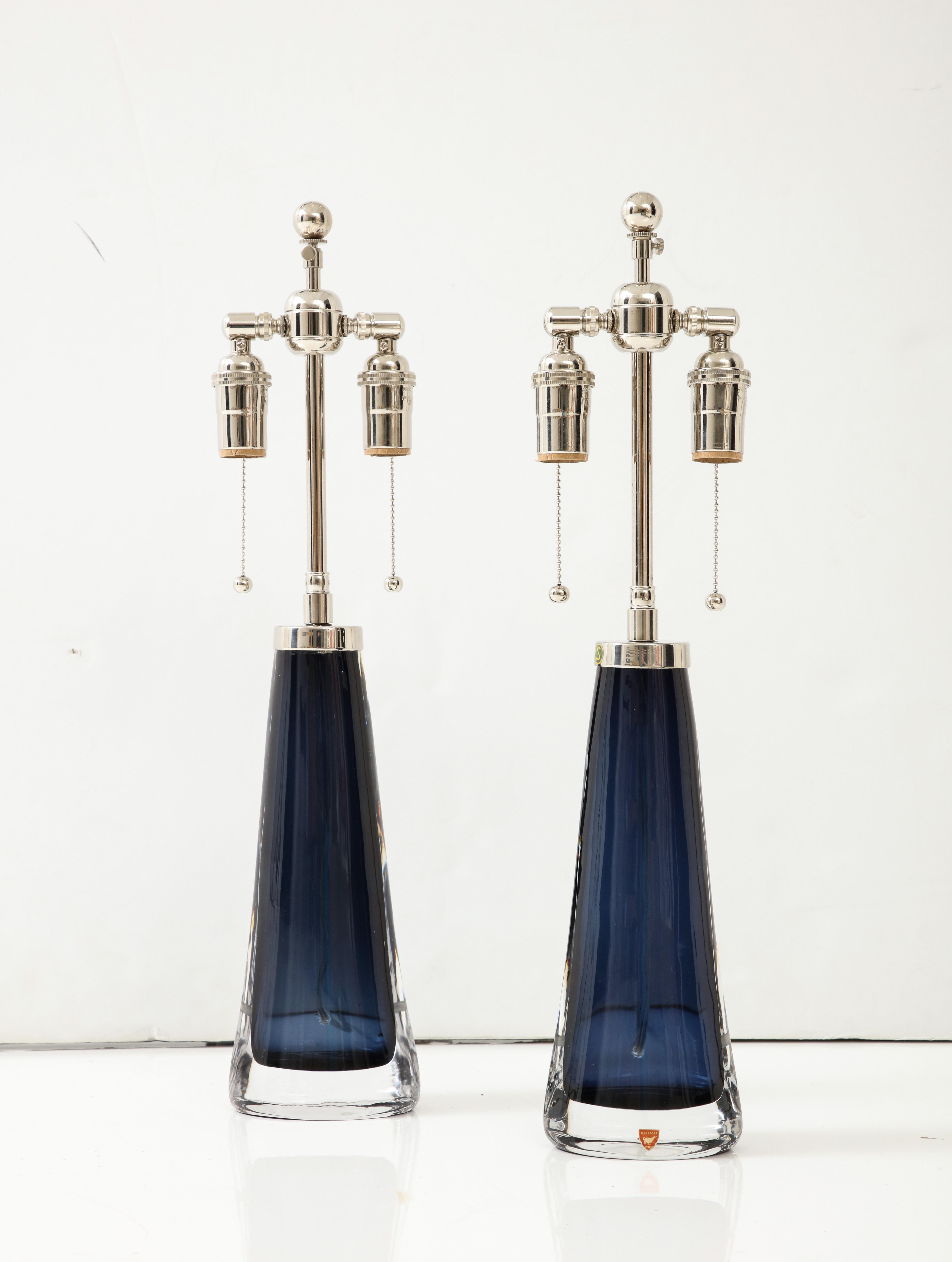 Stunning pair of Extra large Midnight Sapphire blue glass lamps 
designed by Carl Fagerlund for Orrefors
There lamps have been Newly rewired with adjustable polished Chrome
double clusters that take standard size light bulbs.
Each socket takes up to