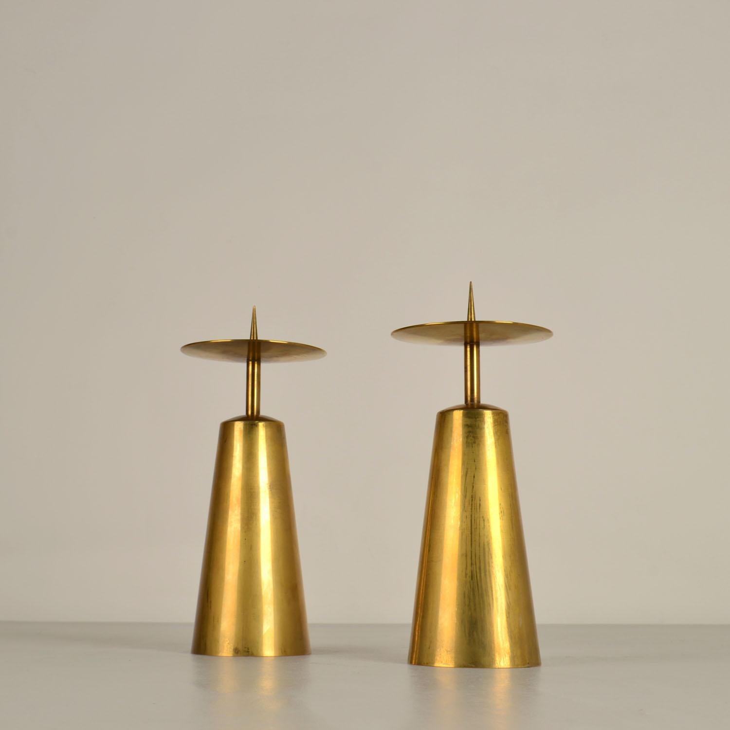 Pair of  Minimalist brass Mid-Century Modern candle holders for 4-5 cm diameter candles. They would have been designed for an altar table in the 1960's but their timeless design and elegance make them fit in any interior.