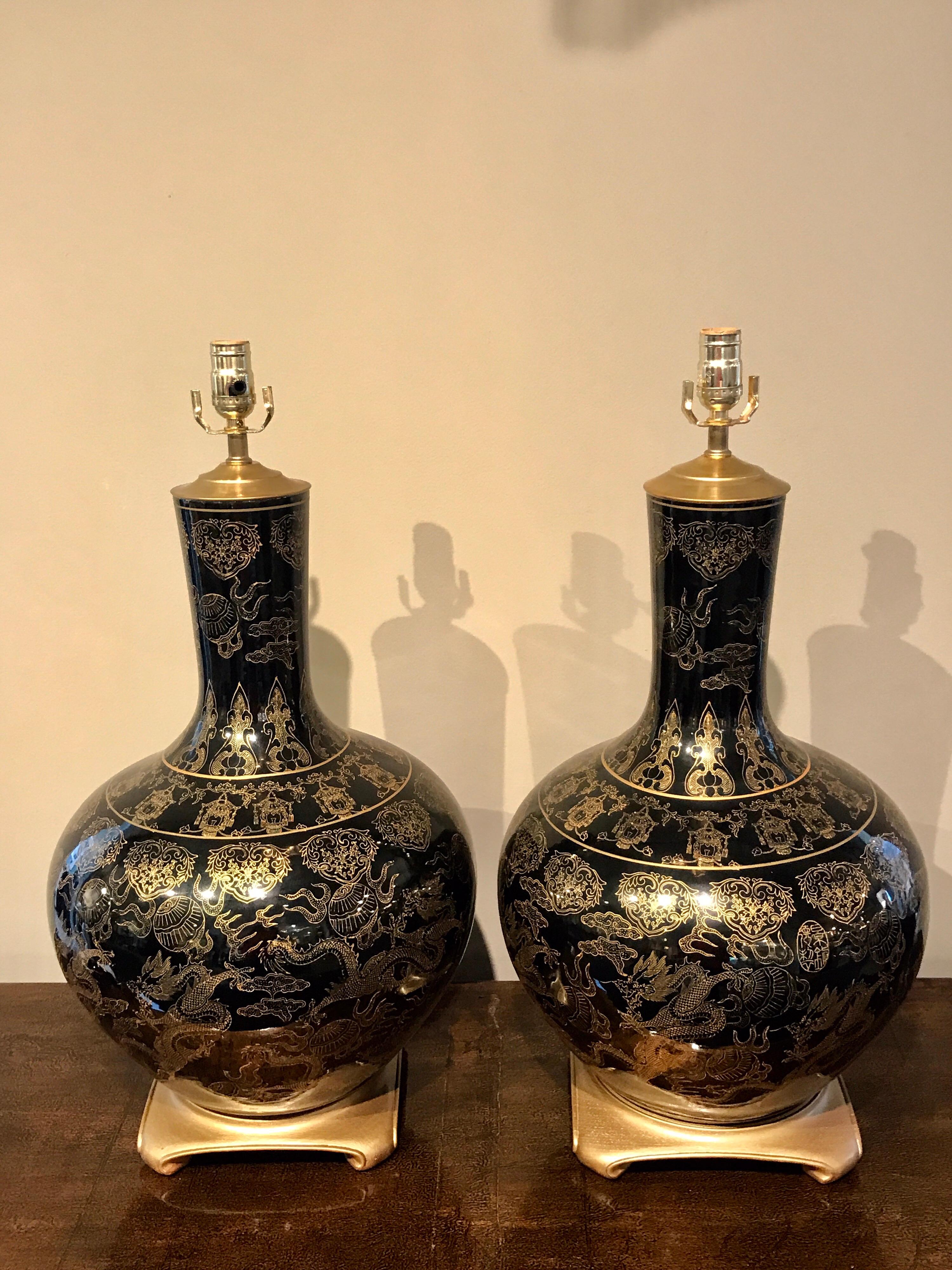 Pair of large mirror black chinese export vases, now as lamps, each one profusely decorated, mounted on giltwood crab leg stand. The height to the top of the socket is 28