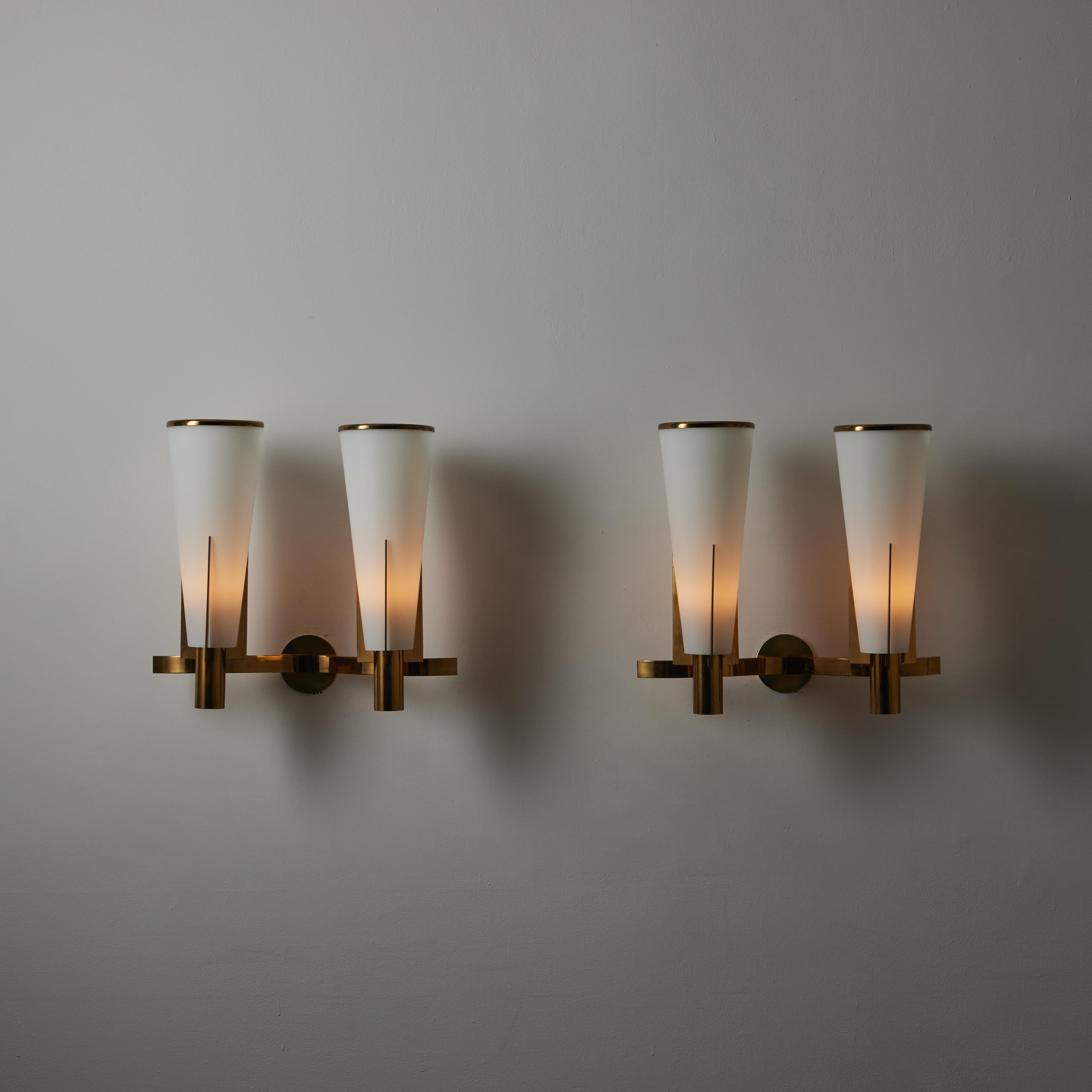 Pair of Large model 2021/2 Sconces by Stilnovo. Manufactured in Italy, circa the 1950s. Large tapered opal glass cylinders paired with polished brass pronged holders. Each sconce holds two e27 socket types adapted for the US. We recommend 25-40w max
