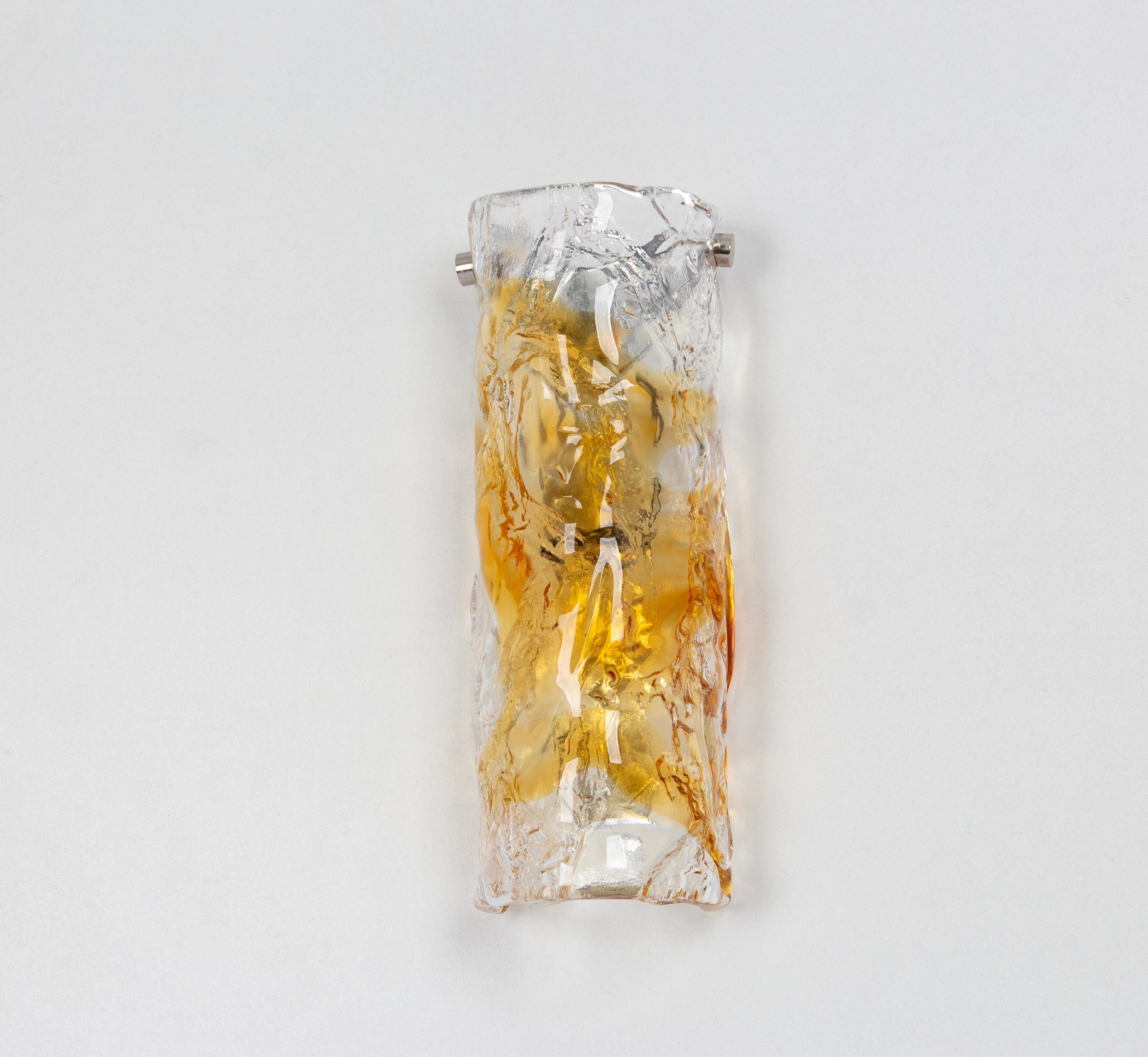  Wonderful pair of midcentury wall sconces with large Murano glass pieces in each lamp, manufactured, circa 1970-1979.

Each sconce needs 1 x E14 small bulbs 
Light bulbs are not included. It is possible to install this fixture in all countries (US,