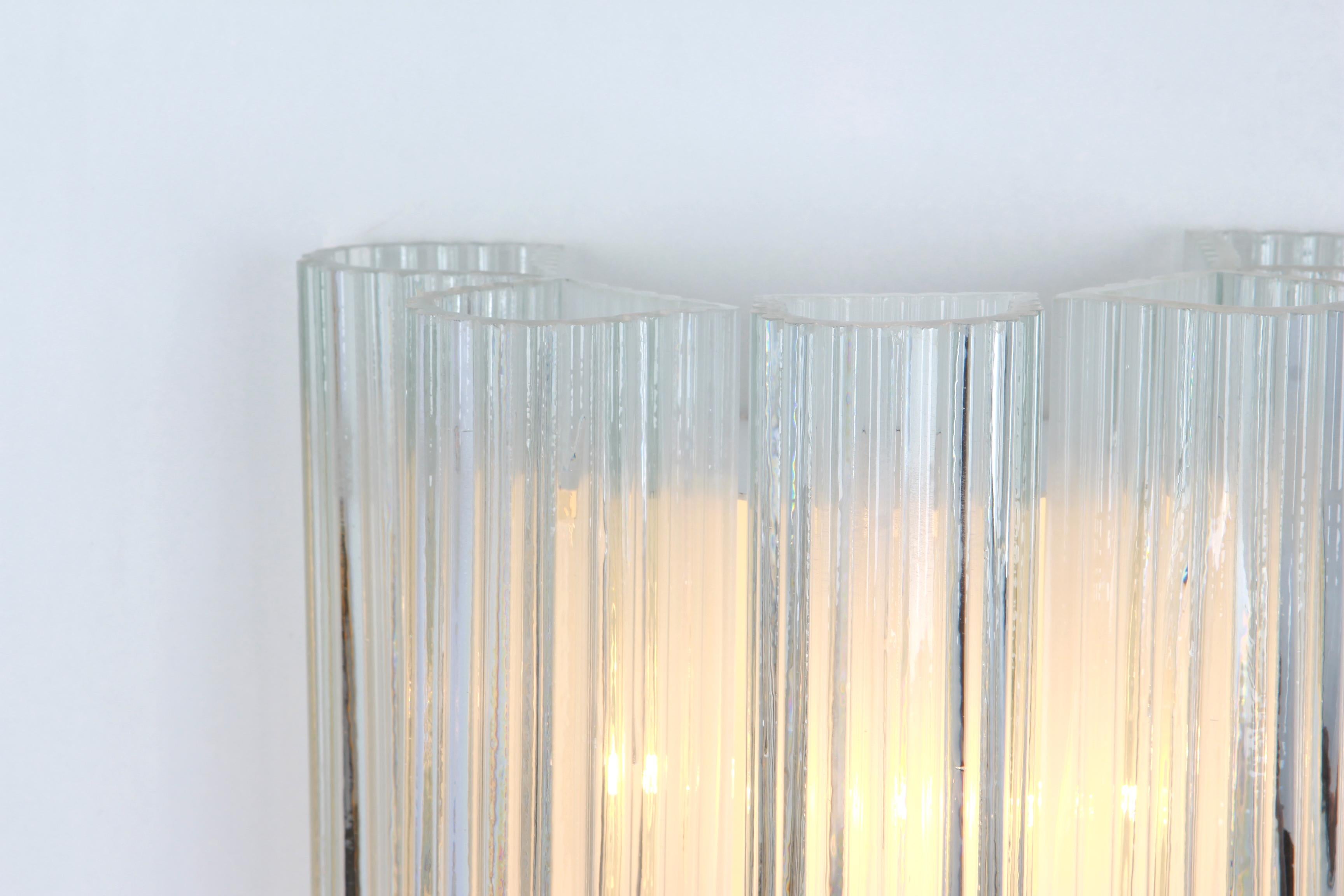 Pair of midcentury wall sconces with Murano glass tubes, made by Doria Leuchten, Germany, manufactured, circa 1960-1969.

Dimensions:
H 12in. x W 8.7 in. x D 5.52 in.
H 30 cm x W 22 cm x D 14 cm

Each wall sconce needs three small bulbs (E-14)