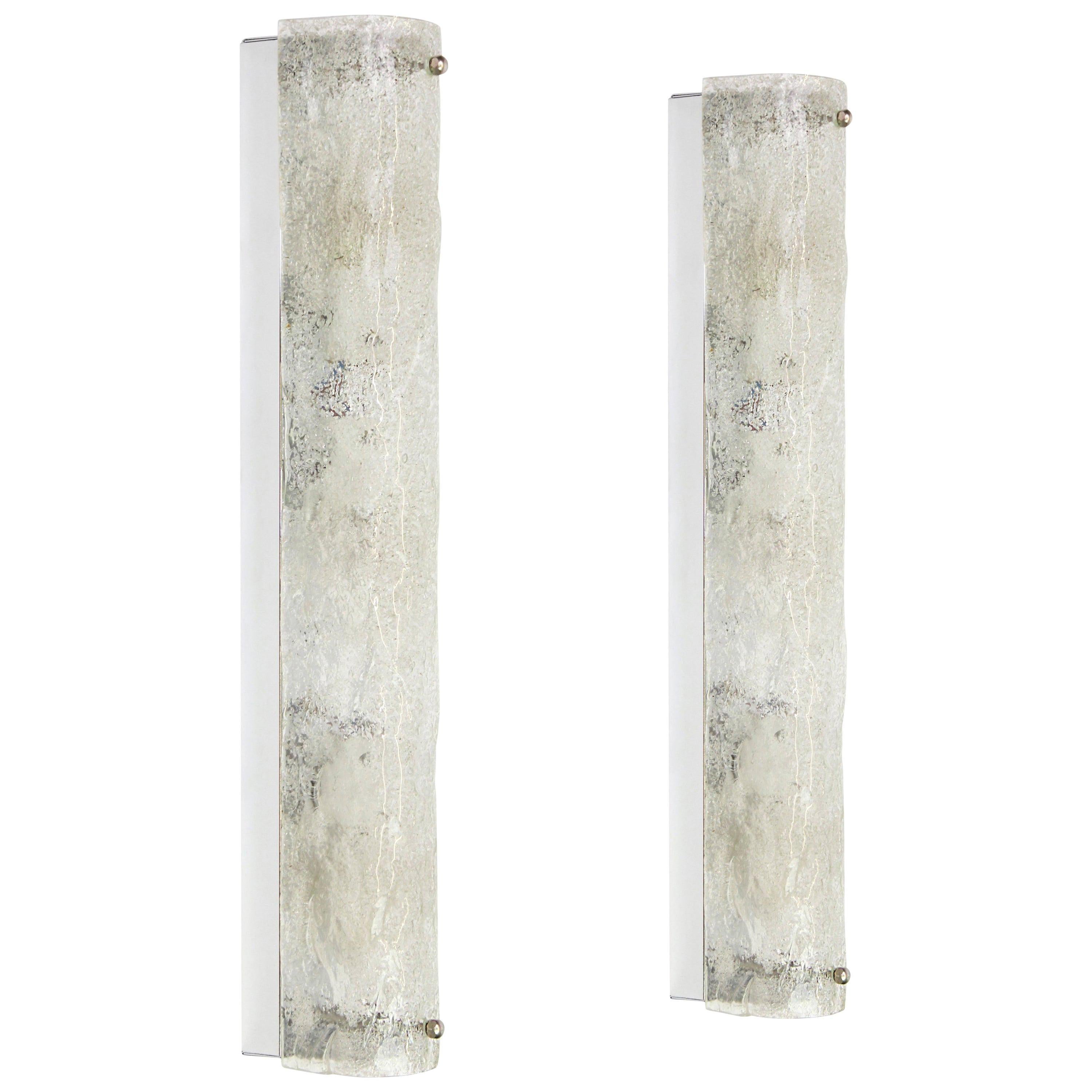 Pair of large handcrafted murano glass on a chromed base sconces by Hillebrand, Germany, circa 1960s.

It consists of textured quality clear crystal tubular shade simulating ice on a chrome frame.
The design allows this light to be placed either