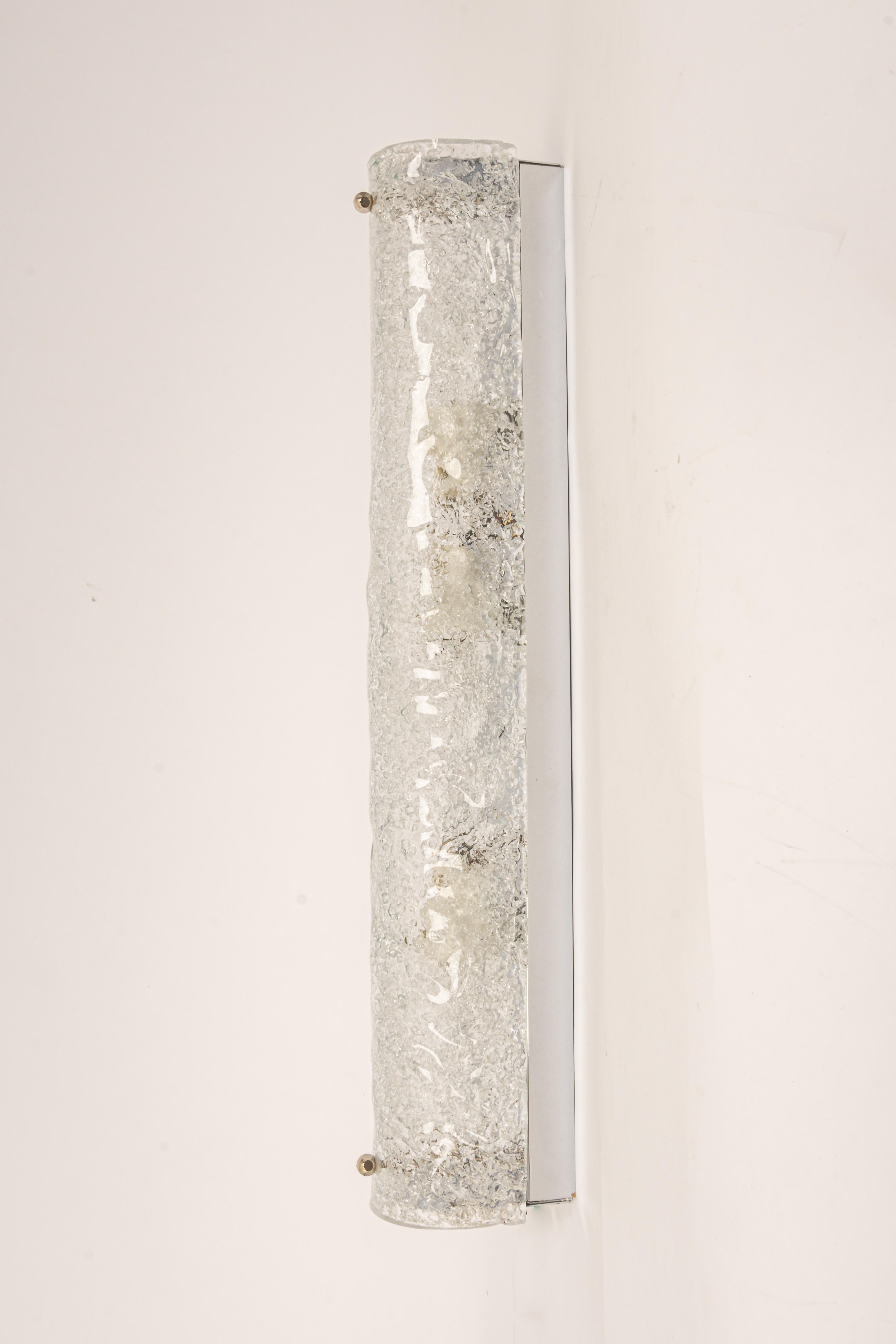 Pair of large handcrafted Murano glass on a chromed base sconces by Hillebrand, Germany, circa 1960s.

It consists of a textured quality clear crystal tubular shade simulating ice on a chrome frame.
The design allows this light to be placed either