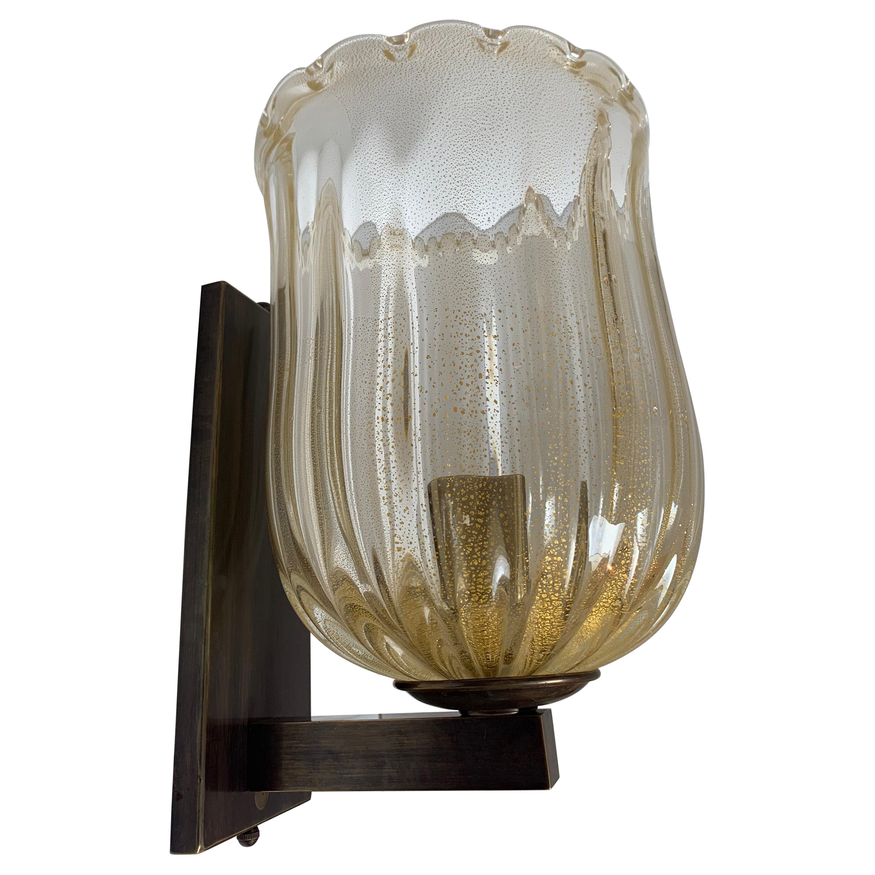 Pair of Murano Glass sconces with real gold fleck mouth blown glass hurricane, All brass hardware with medium Antique acid patina. They are a little heavy and will need to be packed well for safe shipping. A quote can be given at time of sale with
