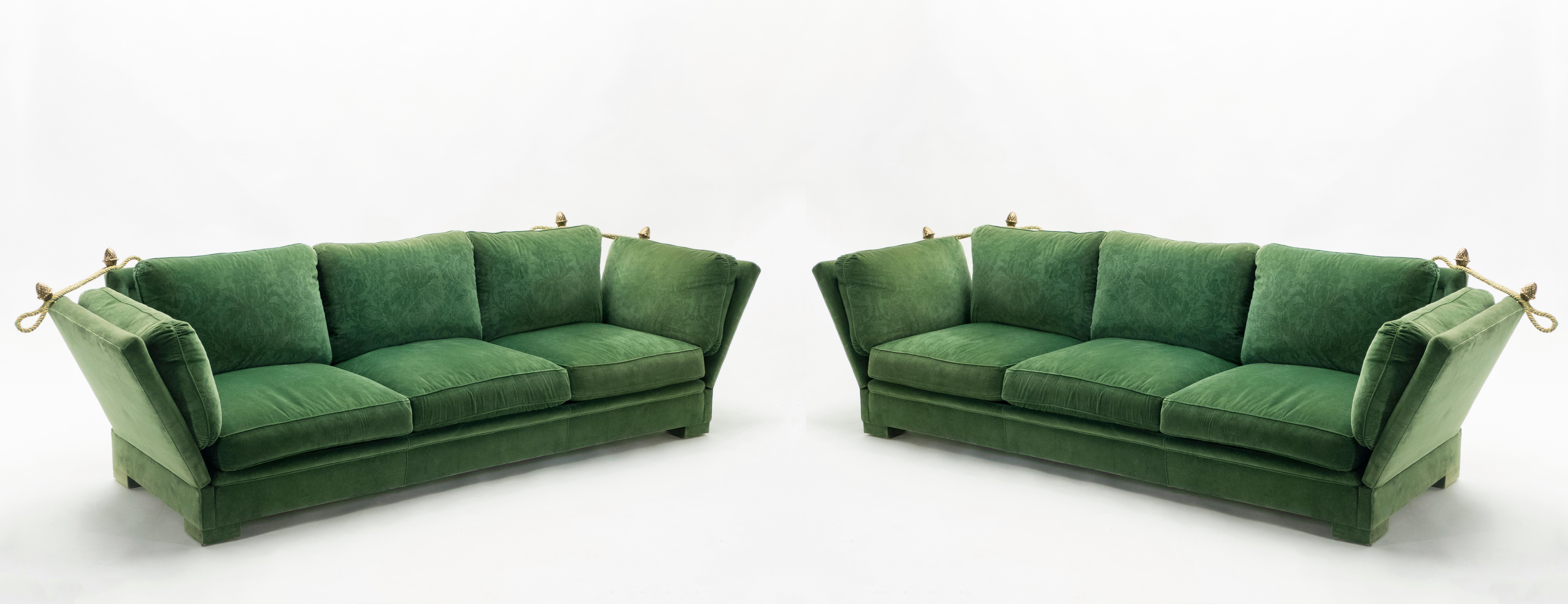 The beautiful forest green velvet fabric of this pair of Mid-Century Modern sofas by Maison Jansen is the original 1970s upholstery and has been maintained in very good vintage condition. With inventive, extendable armrests inspired from 19th