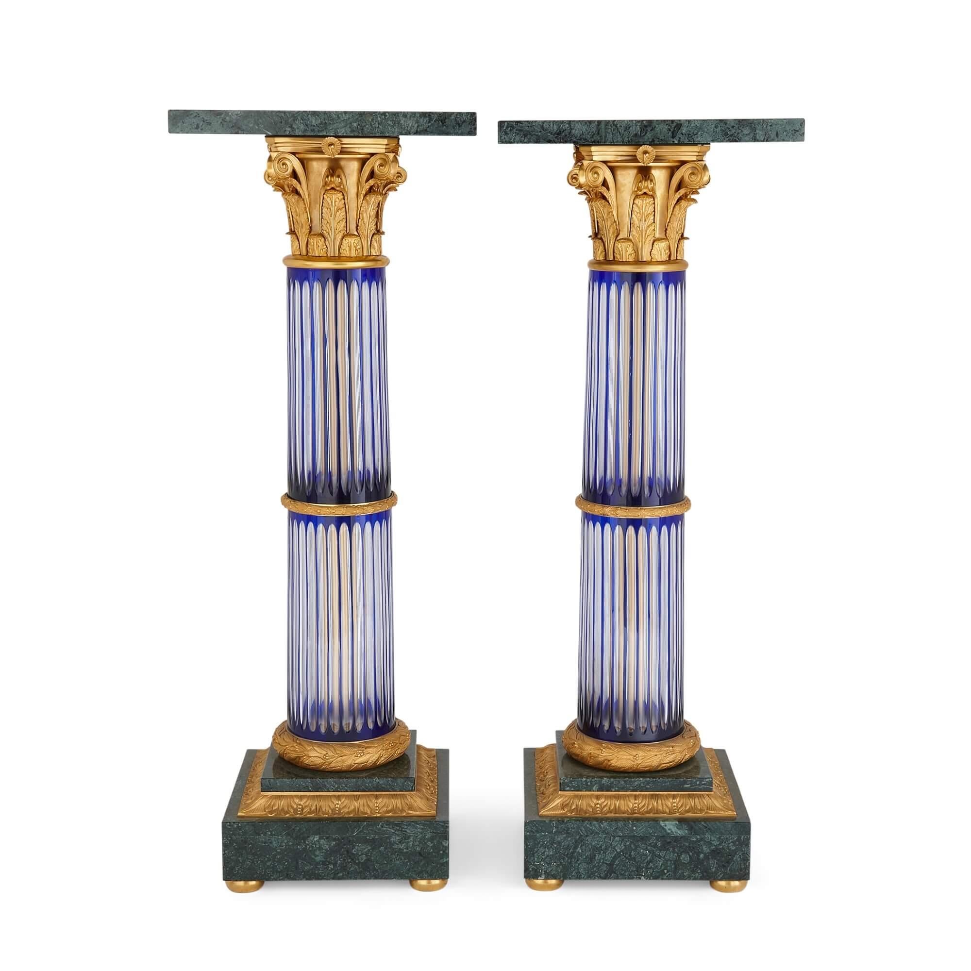 Pair of large Neoclassical style glass, marble and ormolu pedestals
French, 20th century 
Height 114cm, diameter 42cm

This pair of Neoclassical style pedestals have been crafted from marble, ormolu, and coloured glass. 

Green, richly veined
