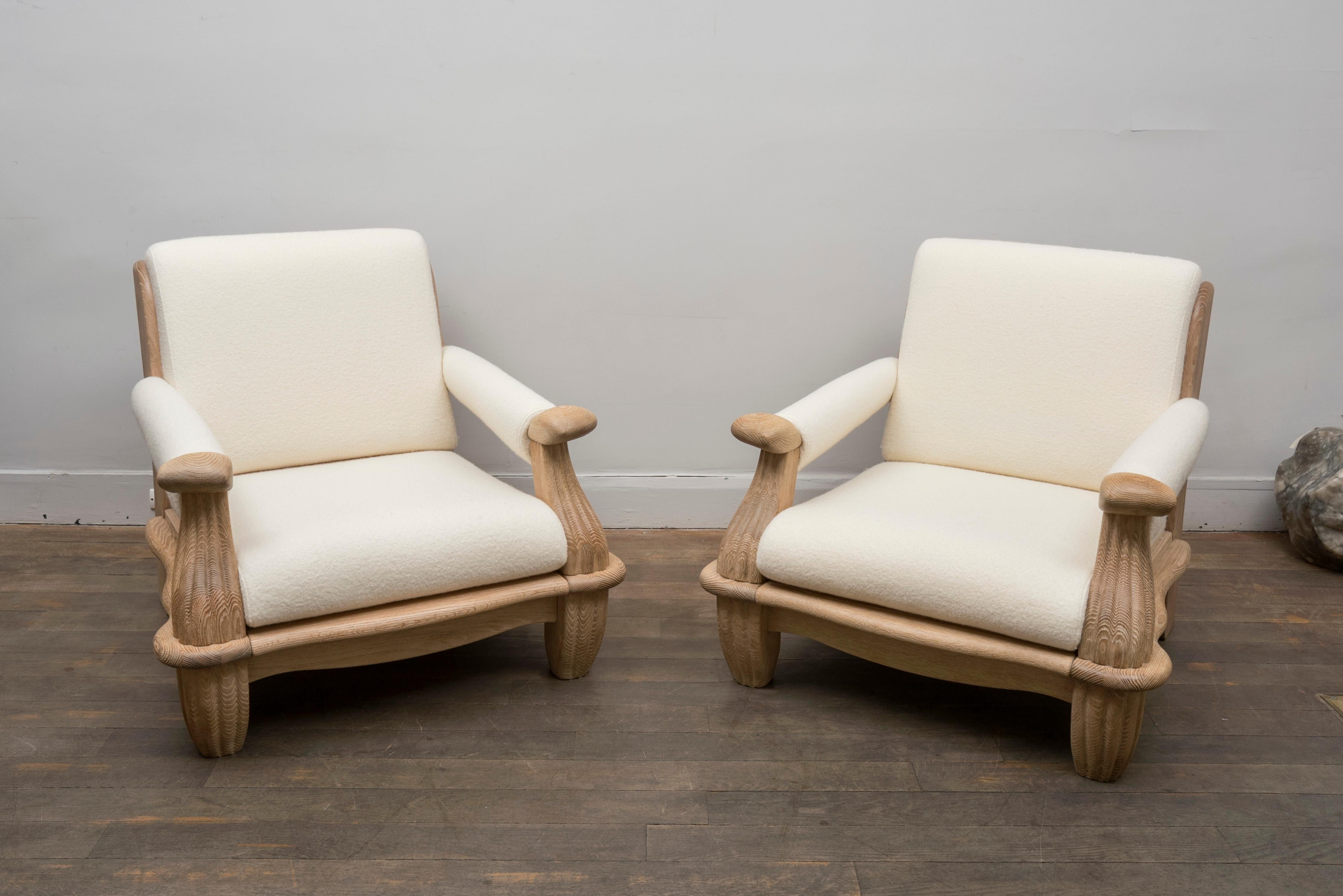A pair of lounge chairs,
Unusual organic armrests and sides
Oak, entirely restored and re upholstered in off-white wool fabric
France, circa 1950.