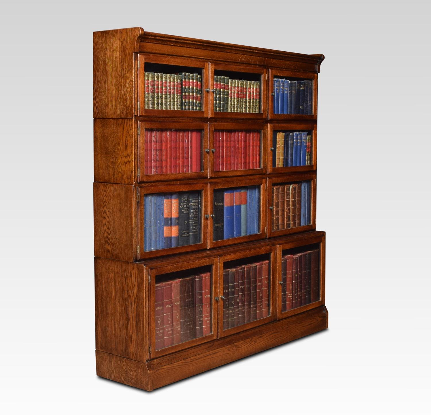 Pair of large oak sectional bookcases, the moulded top above four tiers each tier fitted with three glass doors and having brass knob handles, All raised up on plinth base.
Dimensions:
Height 55.5 inches
Length 52.5 inches
Width 12 inches.