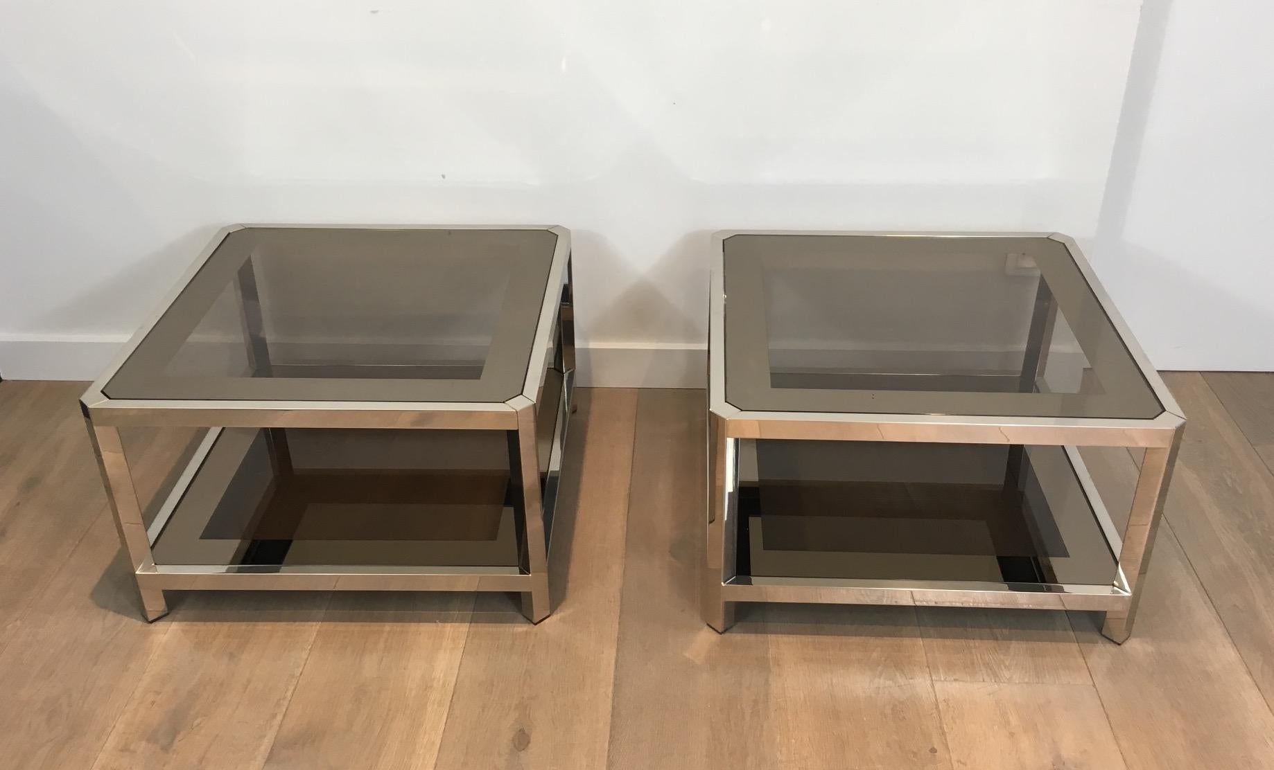 This pair of large octogonal side tables is made of chrome with bronze glass tops. This is a French work, circa 1970.