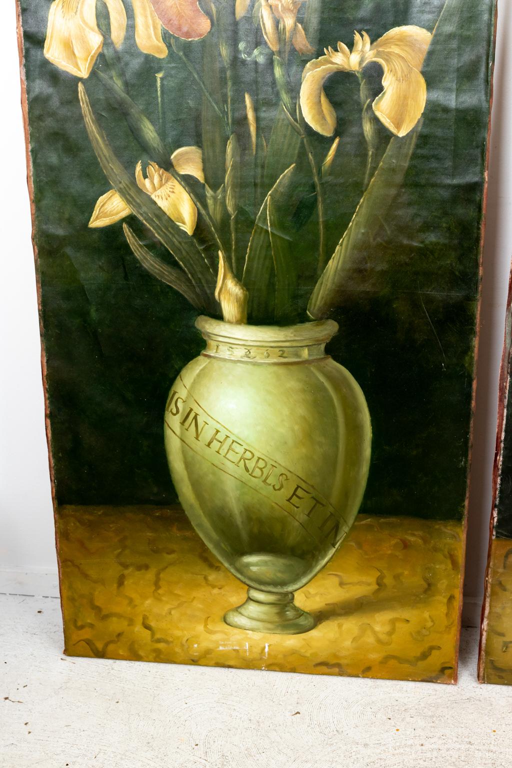 Circa 1930s pair of large oil on canvas paintings of lilies in apothecary jars contracted by a dark background. Please note of wear consistent with age including one small tear in one of the paintings.