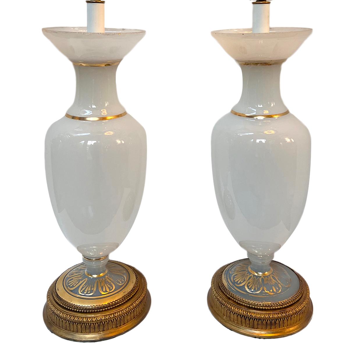 Pair of circa 1930's French opaline glass lamps with gilt details.

Measurements:
Height of body: 23.75