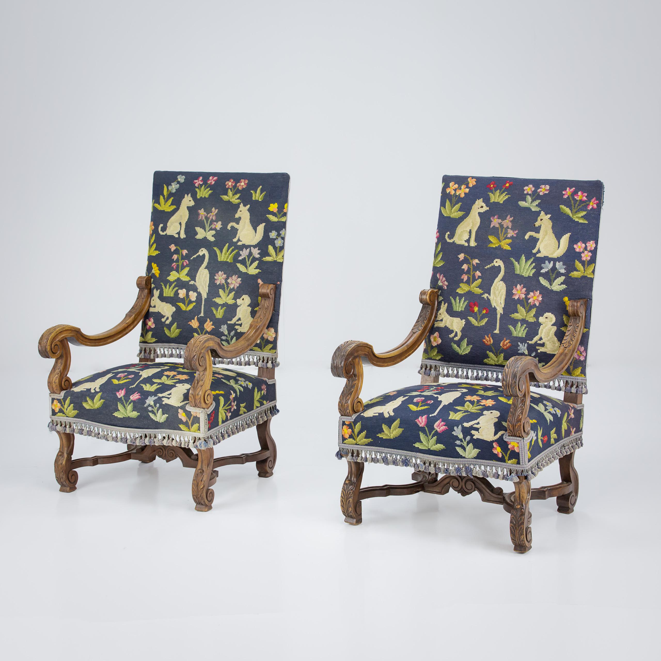 Pair of Large Scale late 19th Century open Armchairs, with wonderful original primitive needlepoint upholstery. France Circa 1920. Seat height 44cm. Needlepoint in good condition, trim has lost one or two tassels.
