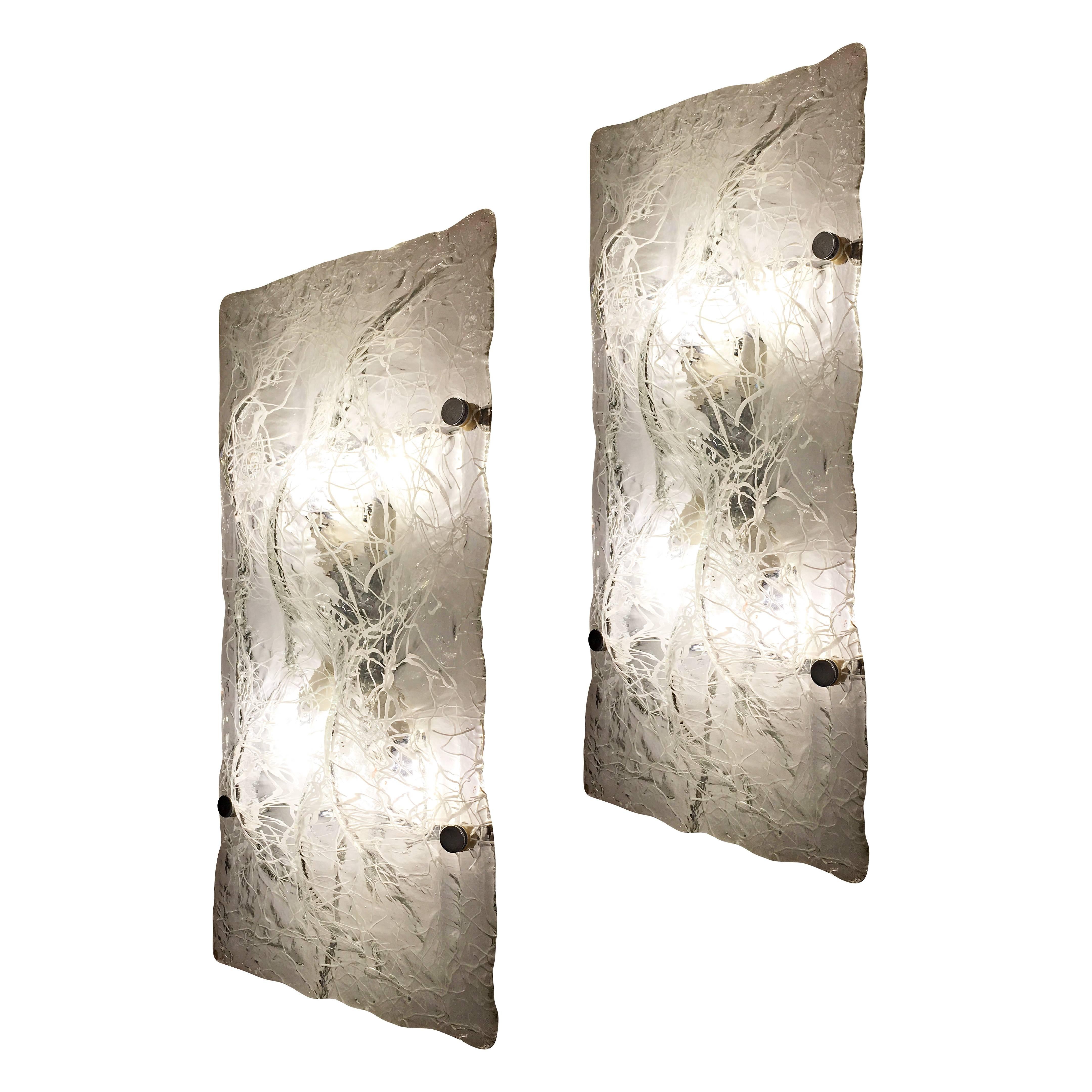 Large organic Murano glass lights by Poliarte which can be mounted as either sconces or wall lights. The clear glass is textured and infused with a web of white glass. The frame is nickel and holds four candelabra sockets. Price per