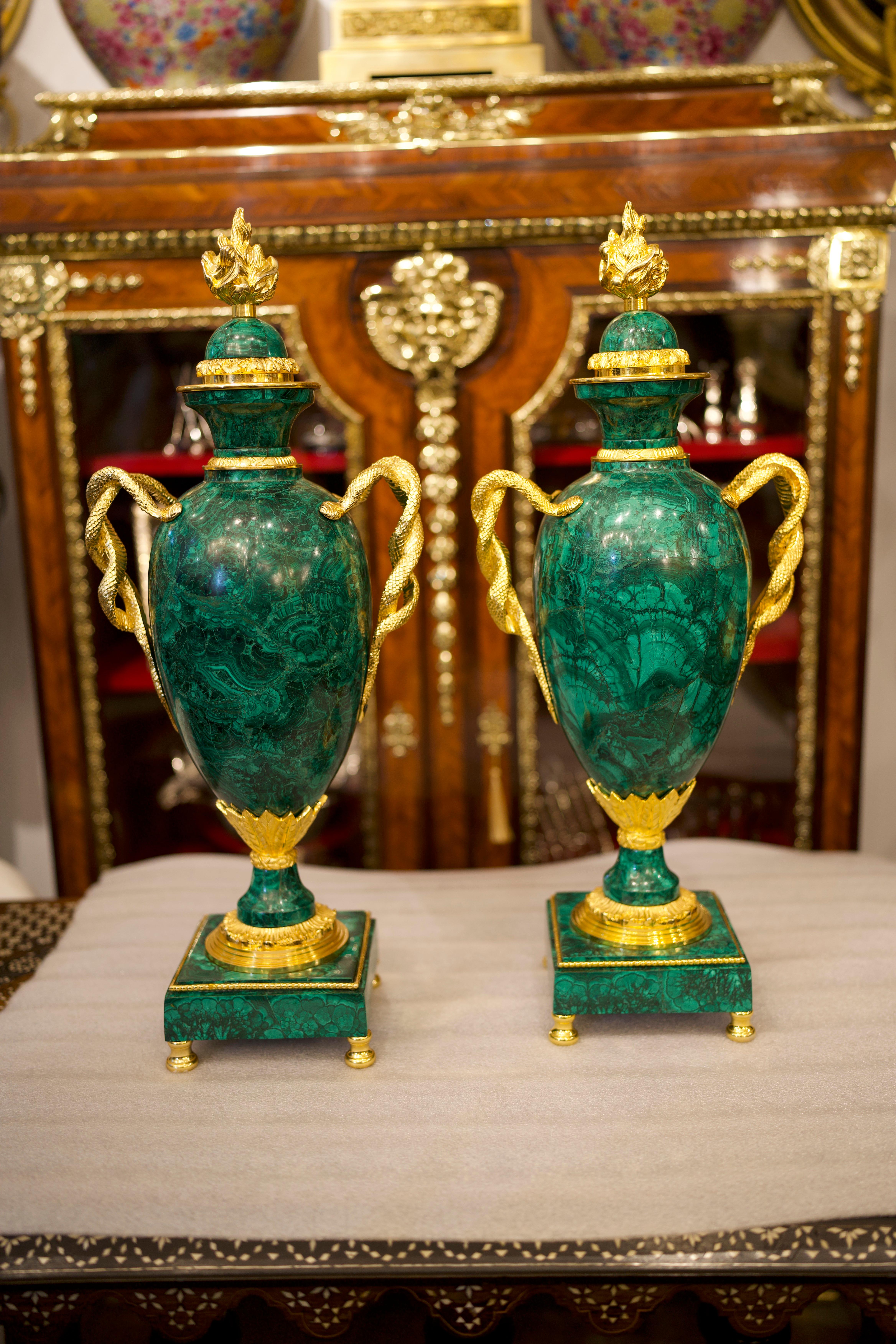 A beautiful pair of large ormolu mounted malachite Empire style vases.

Executed in a mixture of styles but dominated by an Empire influence, these striking malachite and ormolu mounted vases were made in the early twentieth century. They feature