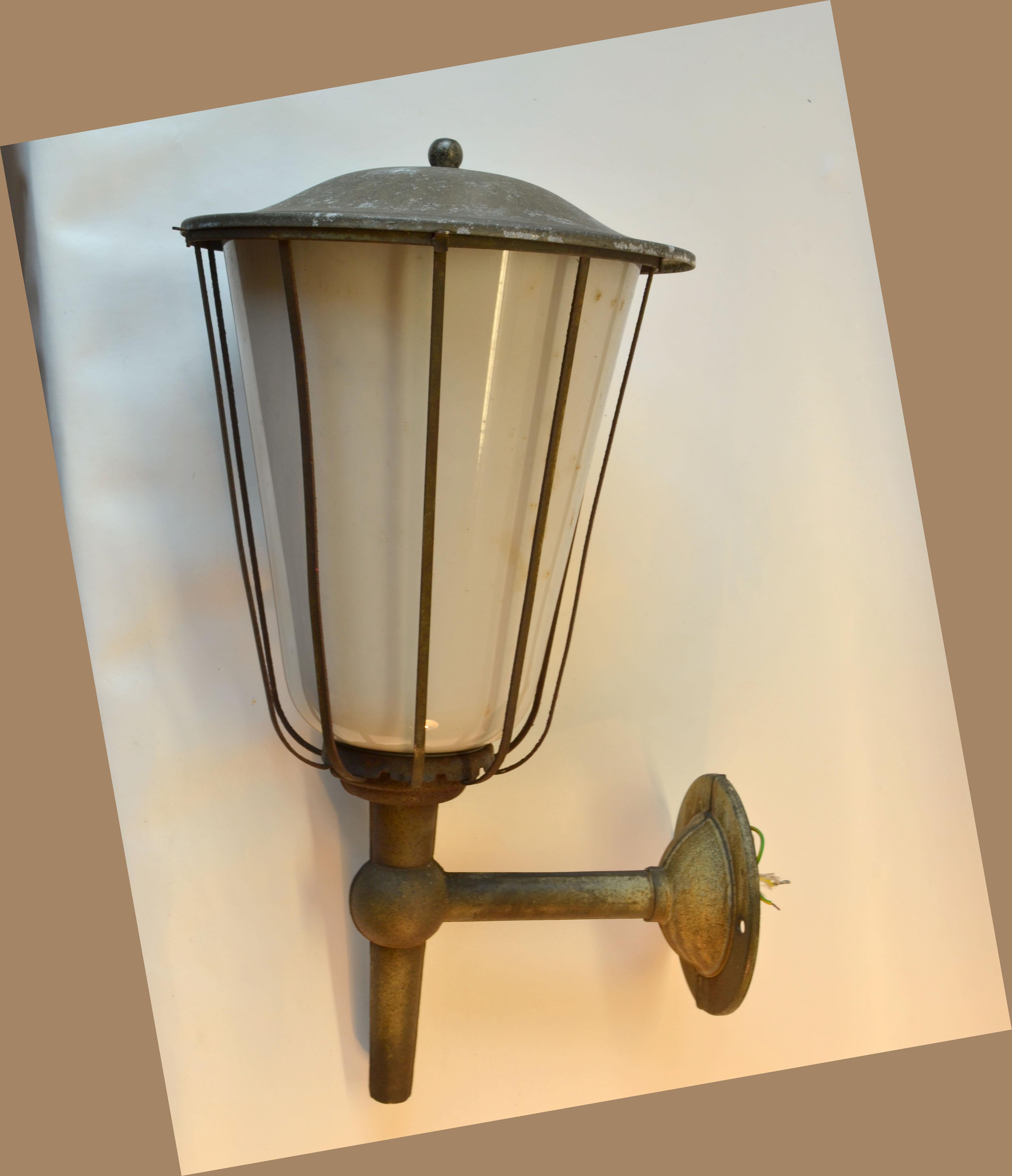 Pair of large outdoor lanterns in zinc plated metal and white glass are early 20th century French. The plating has a nice original patina.
They originated from a castle to the south of Germany near Stuttgart and will make a real statement in- or