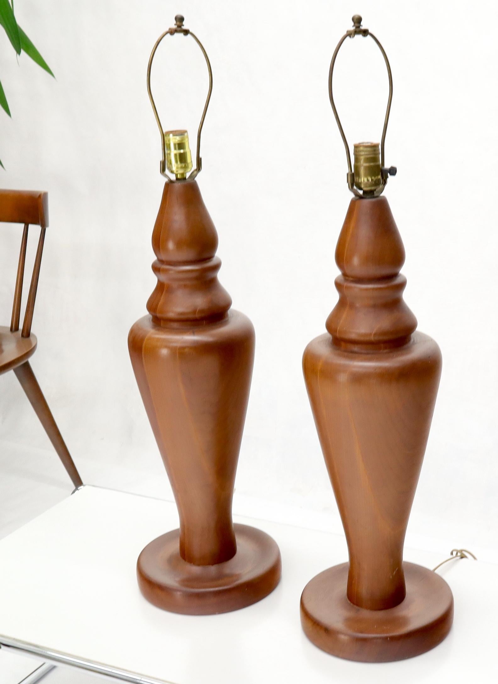 Pair of Mid-Century Modern turned solid teak table lamps.