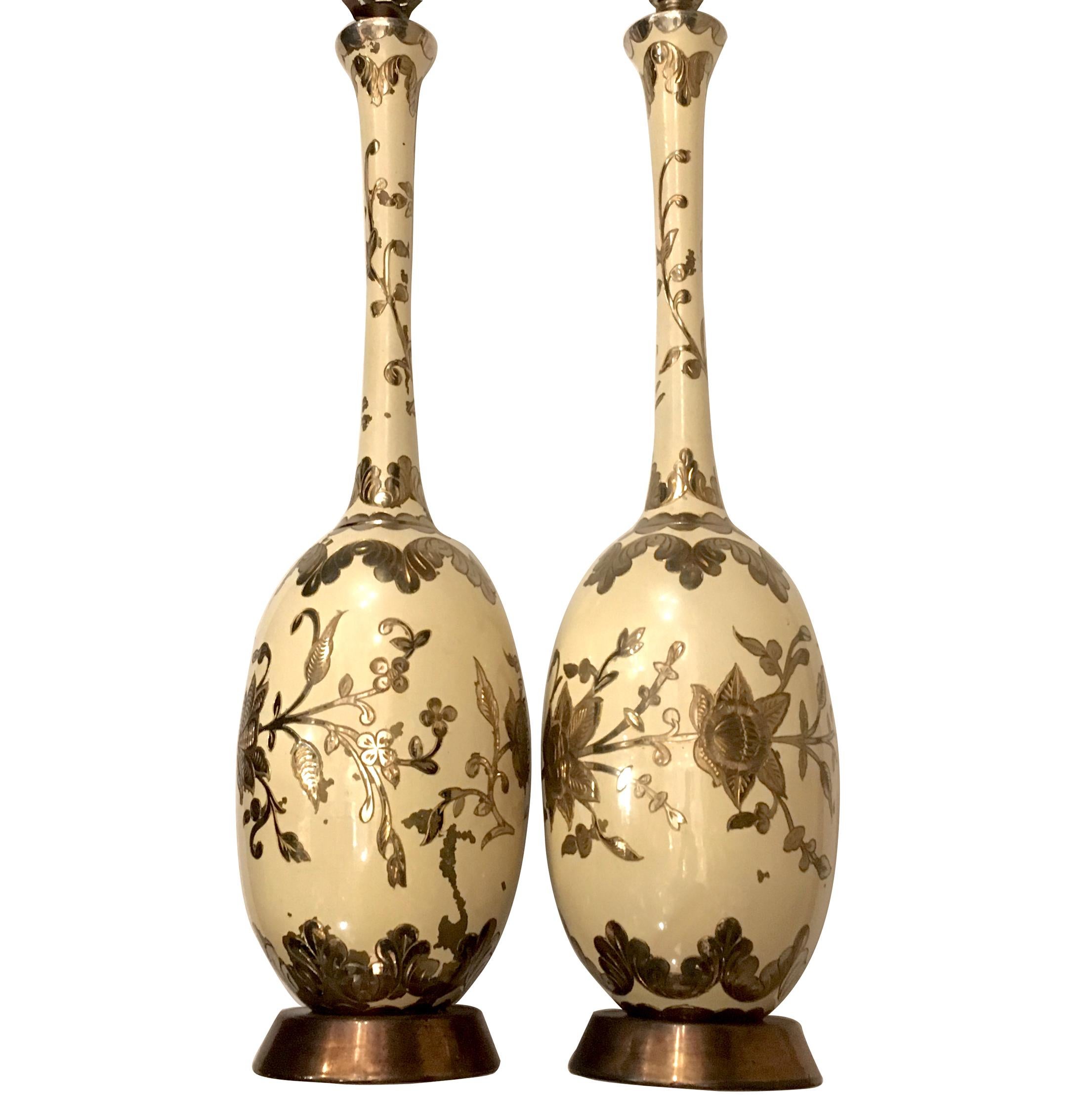 Pair of tall hammered and etched brass table lamps with foliage motif, and with original patinated and painted finish. 

Measures: 25
