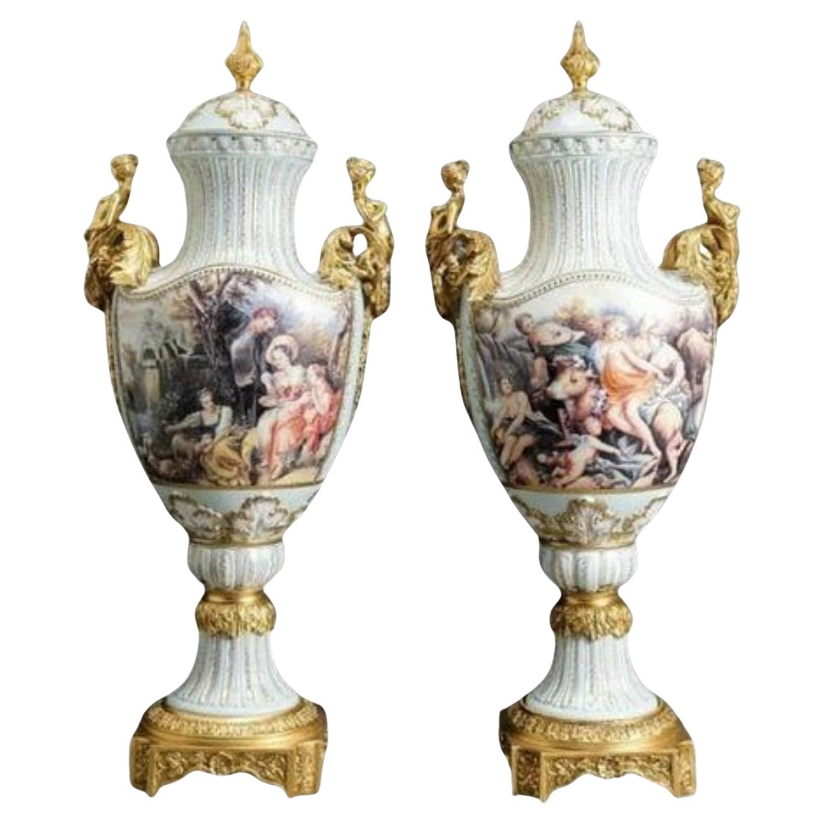 Pair Of Large Painted European Porcelain Urns with Gold Handles For Sale