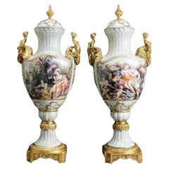 Pair Of Large Painted European Porcelain Urns with Gold Handles