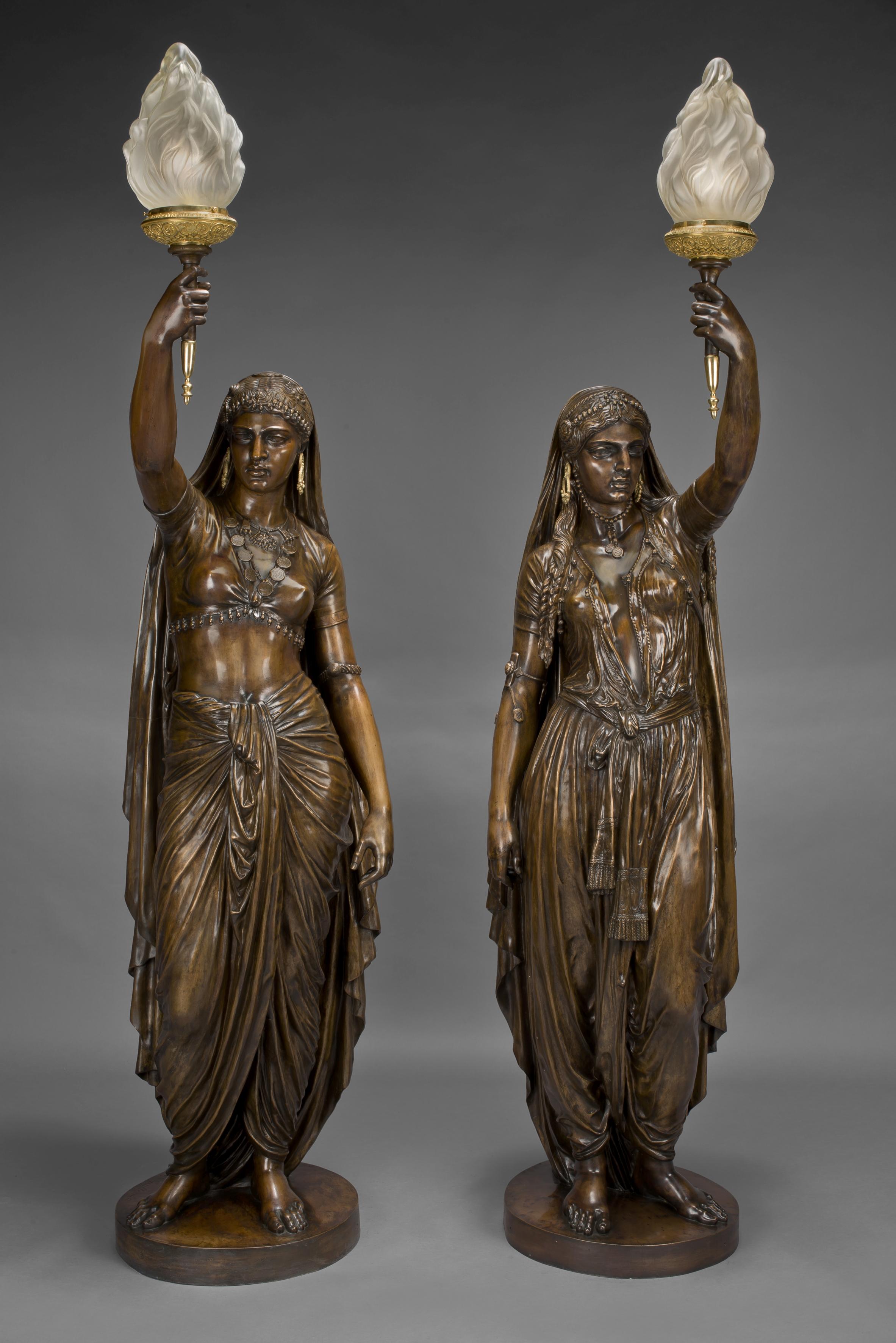 A highly important pair of large patinated bronze figural torcheres by Émile Guillemin, cast by Ferdinand Barbedienne.

French, dated 1872.

Barbedienne Title: 'Deux Femmes, Indienne et Persane'.

Incised 'Ele. Guillemin 1872' and bearing the