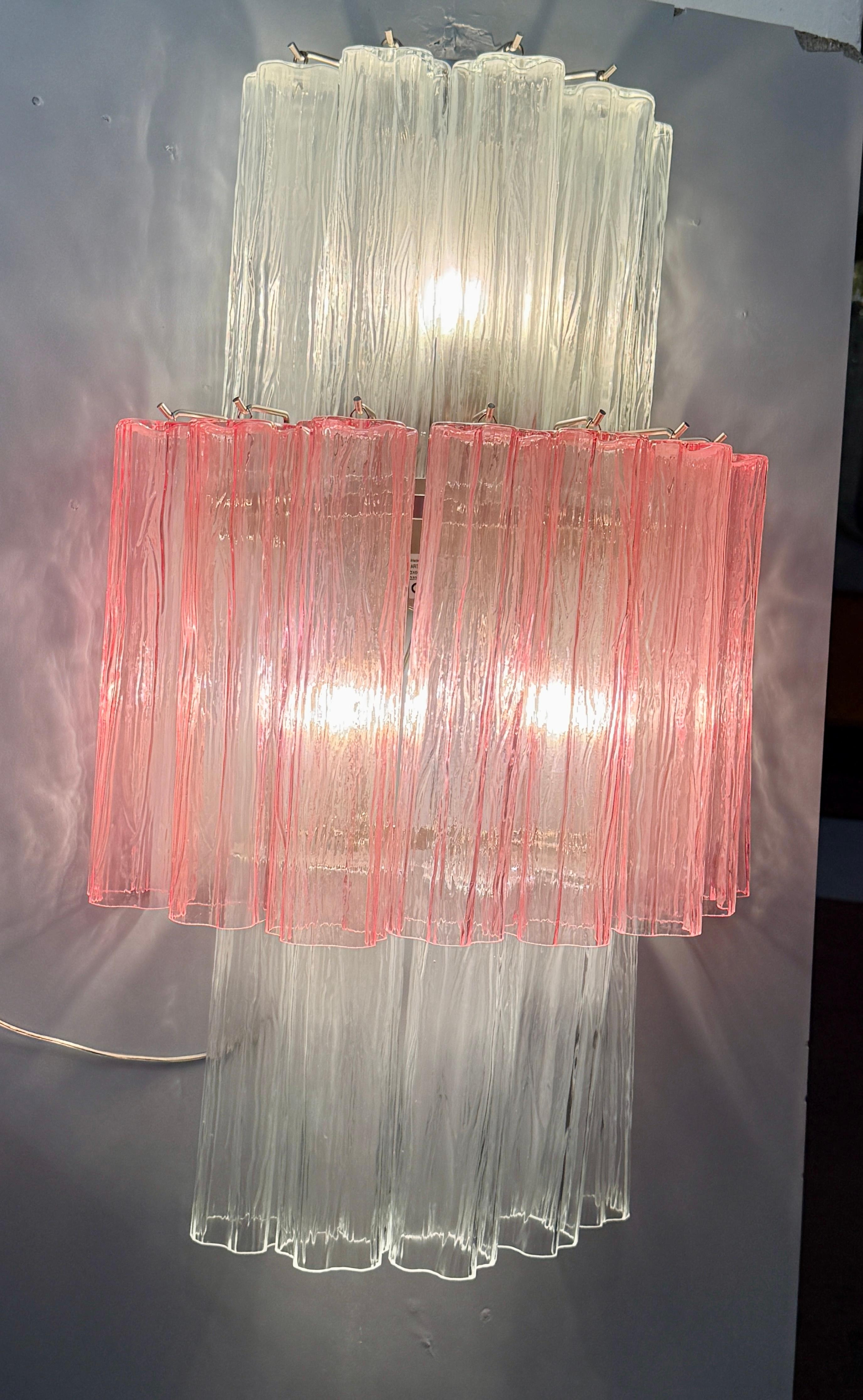 Pair of monumental wall lights composed by dozens of precious 'Tronchi' Murano glasses on tree levels with pink and clear color glasses.
Available 2 pairs of sconces and a  chandelier .
This light fixture can be disassembled and the glasses