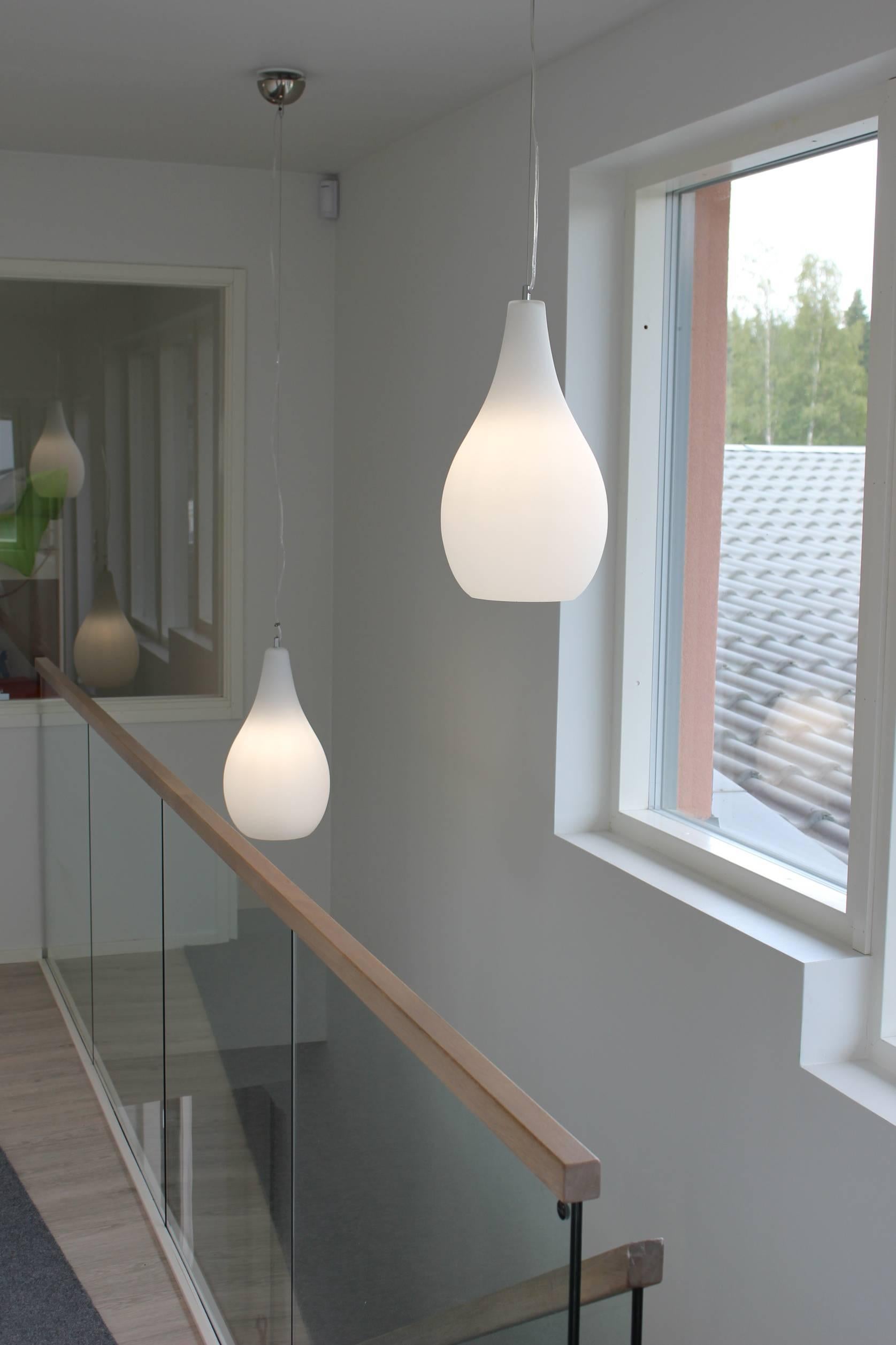 Pair of Large 'Pisara' Opaline Glass Pendant Lamps by Innolux Oy, Finland. The Pisara is a stylish and high-quality pendant executed in high-quality blown opaline glass with metal suspension wire. A quintessentially Finnish design in the tradition