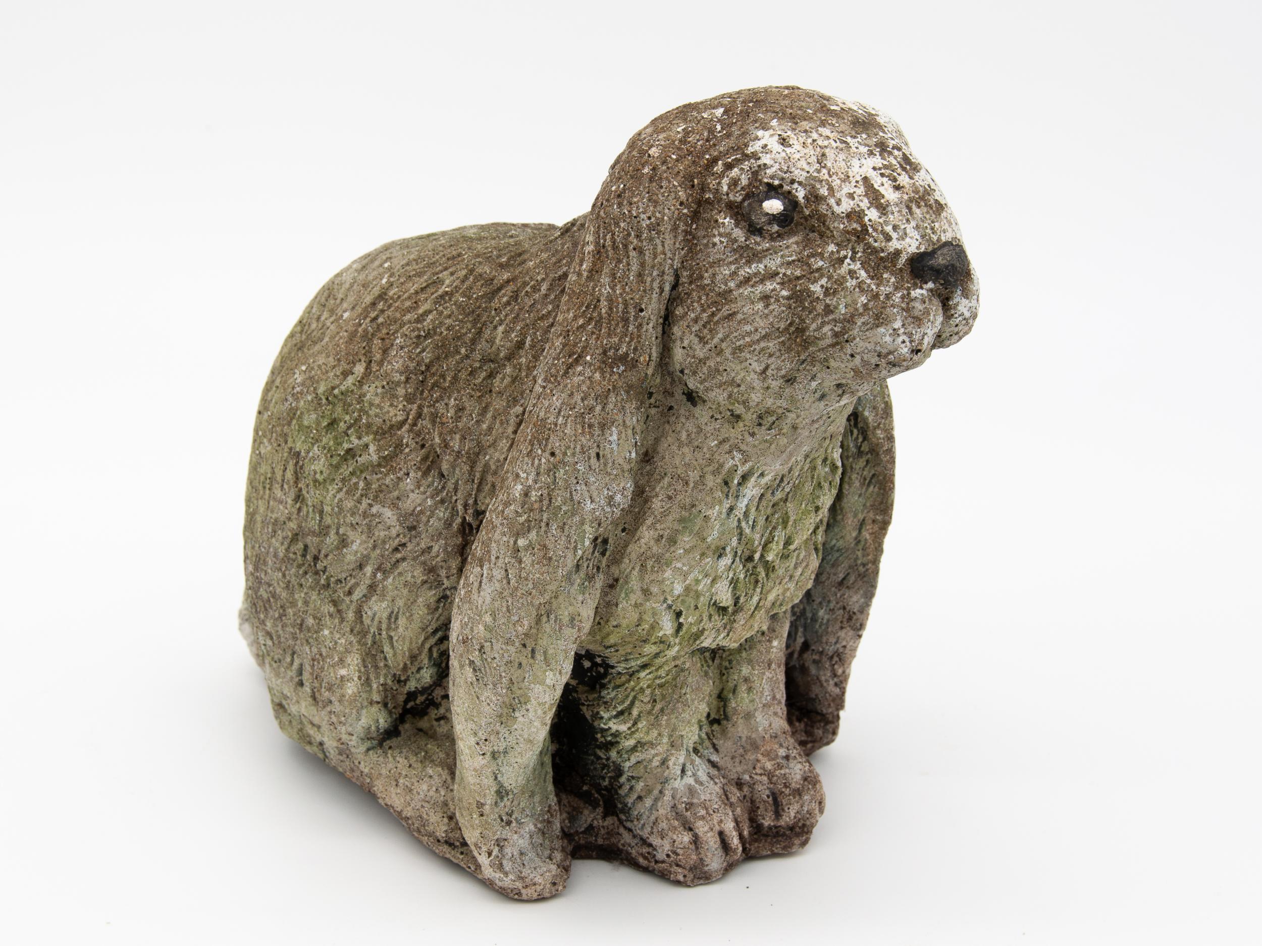 Pair of large rabbits with floppy ears out of cast concrete. Natural patina from outdoor exposure.