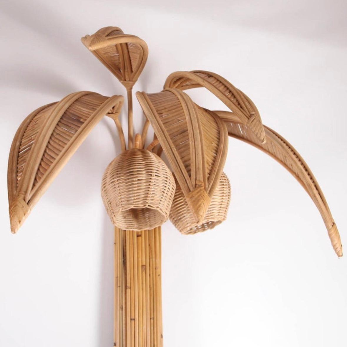 Very decorative pair of large rattan « palm tree/ coconut trees » wall lights with 5 adjustable palms that come off for the shipping and lights in the coconuts. 

Unique sculptural design from the seventies, high quality work entirely hand made,