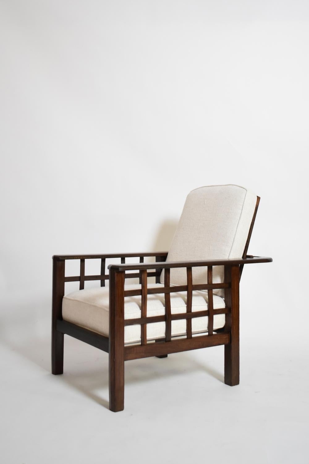 Pair of large exotic wood armchairs with stained wood frames and three-tiered reclining backs. In the style of Francis Jourdain. France, 1930s.