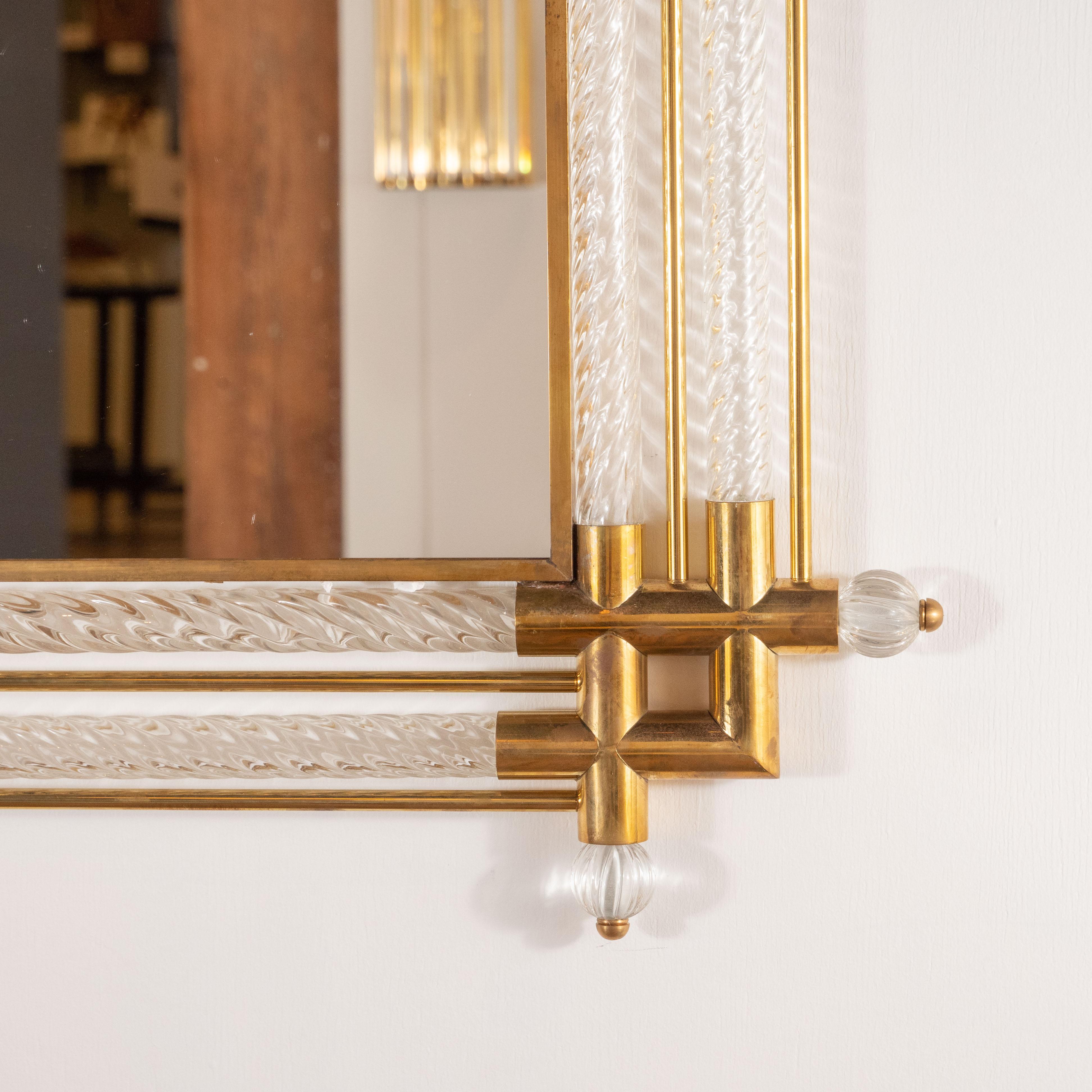 This pair of rectangular clear Murano glass mirrors with brass detailing was handmade in Venice, Italy and is reminiscent of Venini works. Made of clear Murano glass, hand blown with a twisted effect for texture and depth. Linear brass rods and
