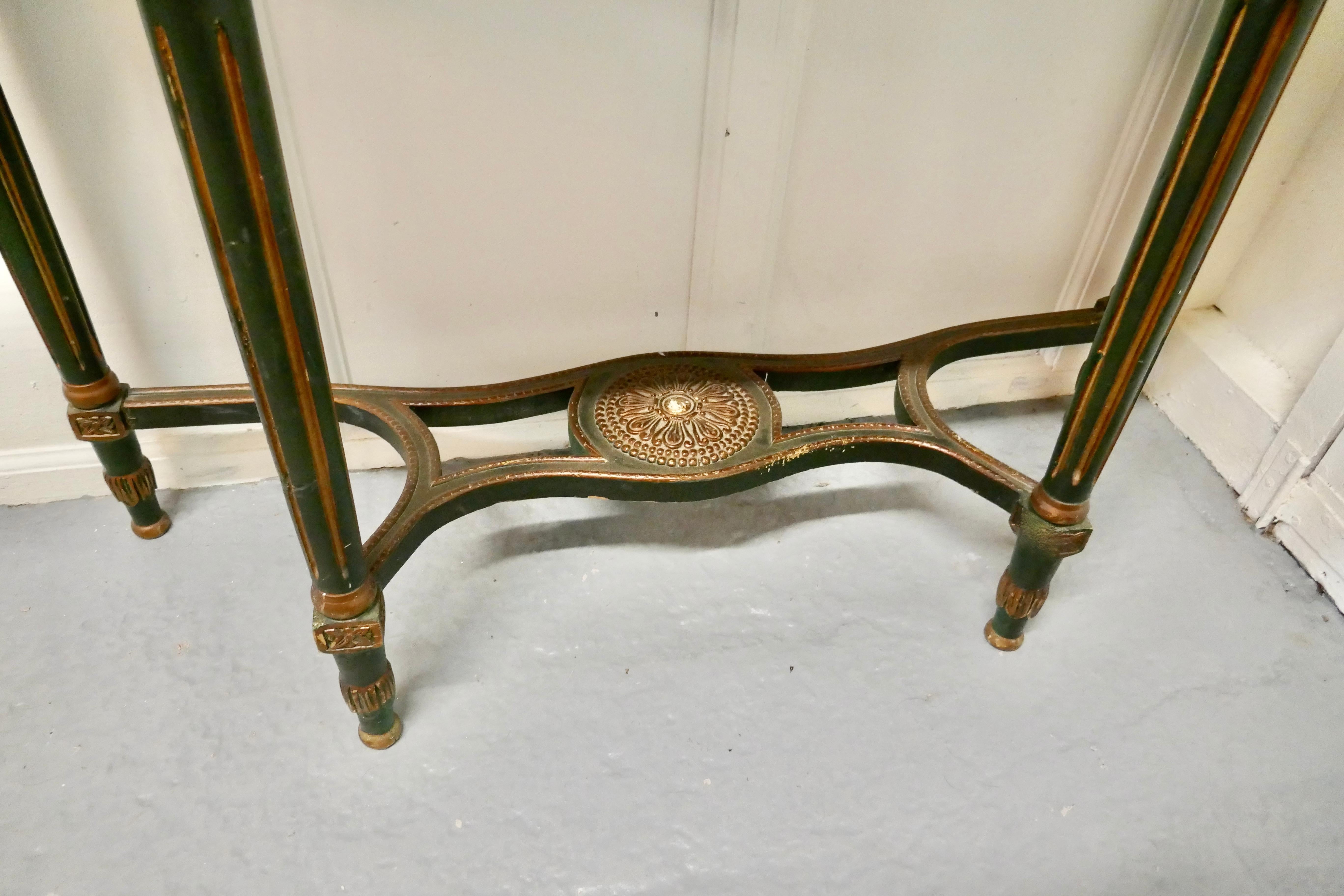 Pair of large Regency style painted console tables

This is a very attractive pair, the tables have a decorated frieze and stretcher and the fluted legs are painted in Regency stripe 
The tables Stand on elegant fluted tapering legs with a large
