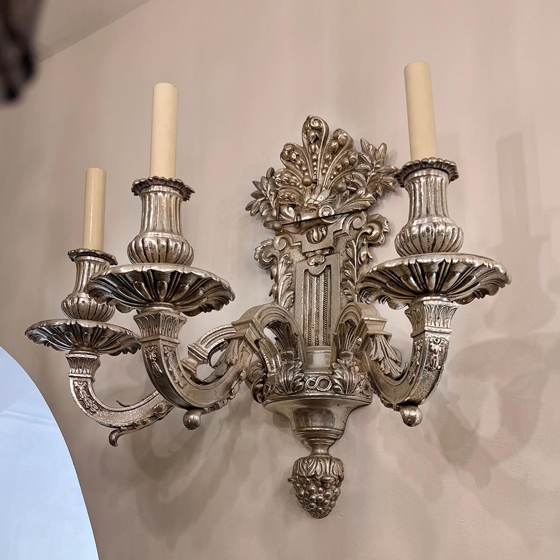 A pair of 19th century English Regency style silver-plated 3-light sconces. 

Measurements:
Height: 18.5