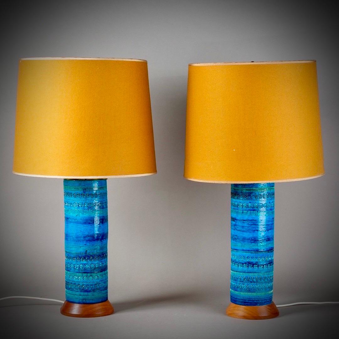 A stunning pair of very large 'Rimini Blue' table lamps. Made in Italy in the 1960s, With the original lampshades. Aldo Londis iconic ceramics design, embossed with abstract motifs and shapes and glazed in vibrant shades of blue.

The lamps has a
